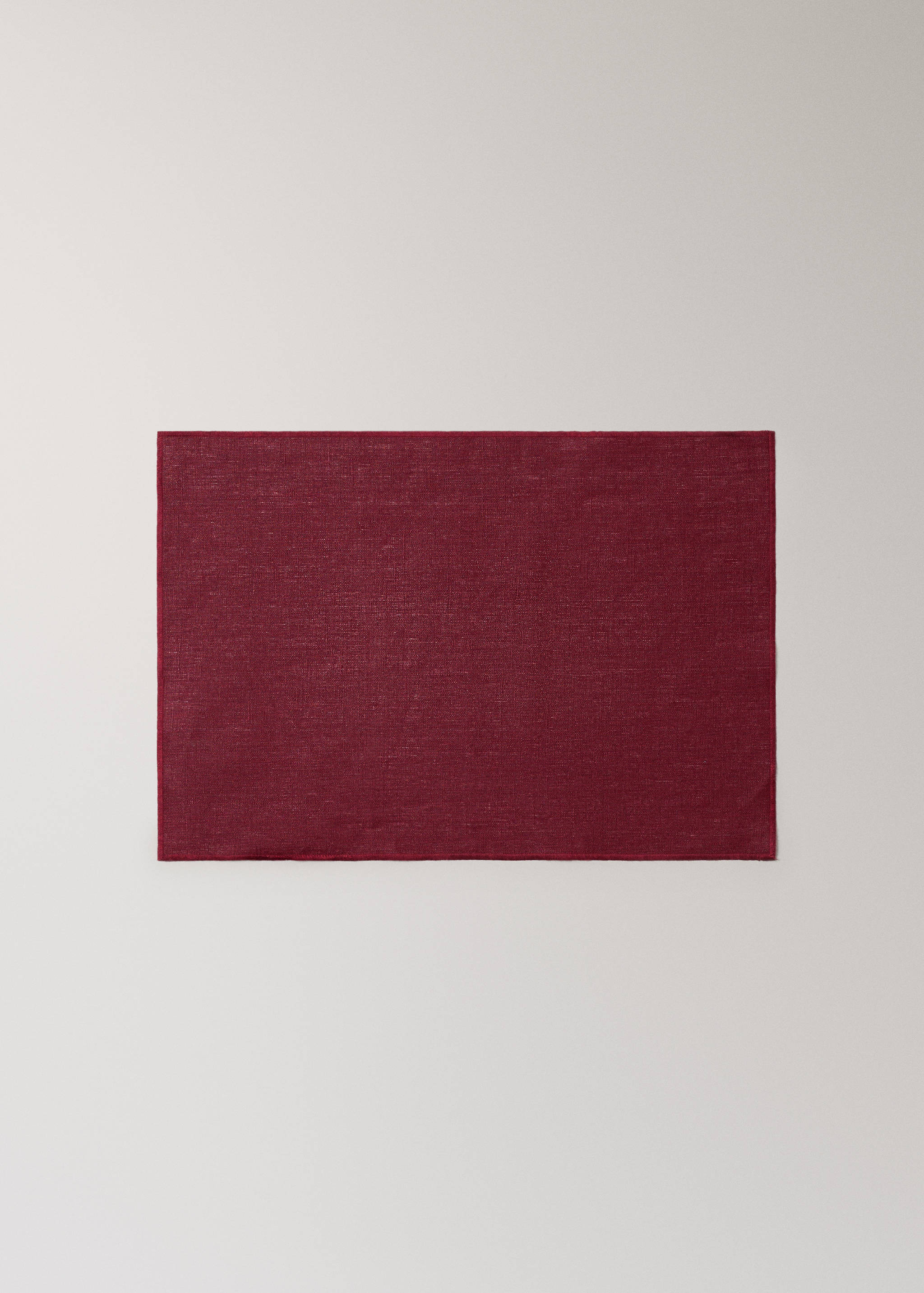 Solid burgundy red woven placemat.