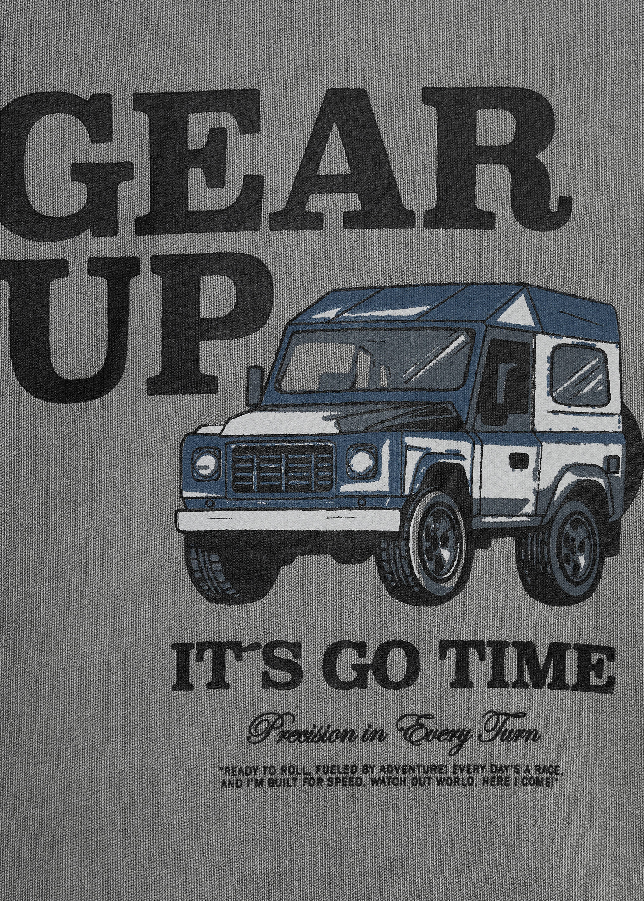 Grey sweatshirt detail with a graphic print of an off-road vehicle and text.