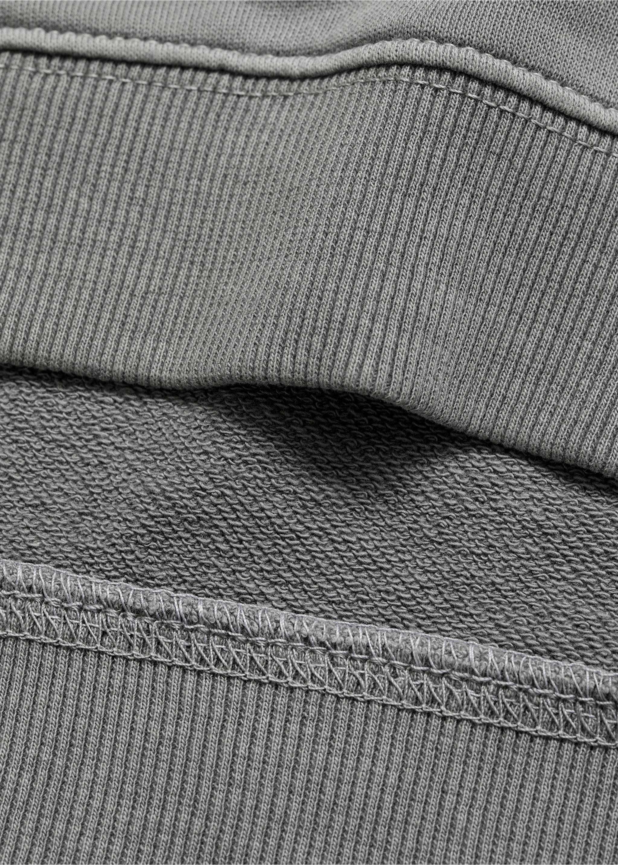 Close-up of grey sweatshirt fabric showing the ribbed hem and interior fleece texture., Grey. Ref: 17024419-00.