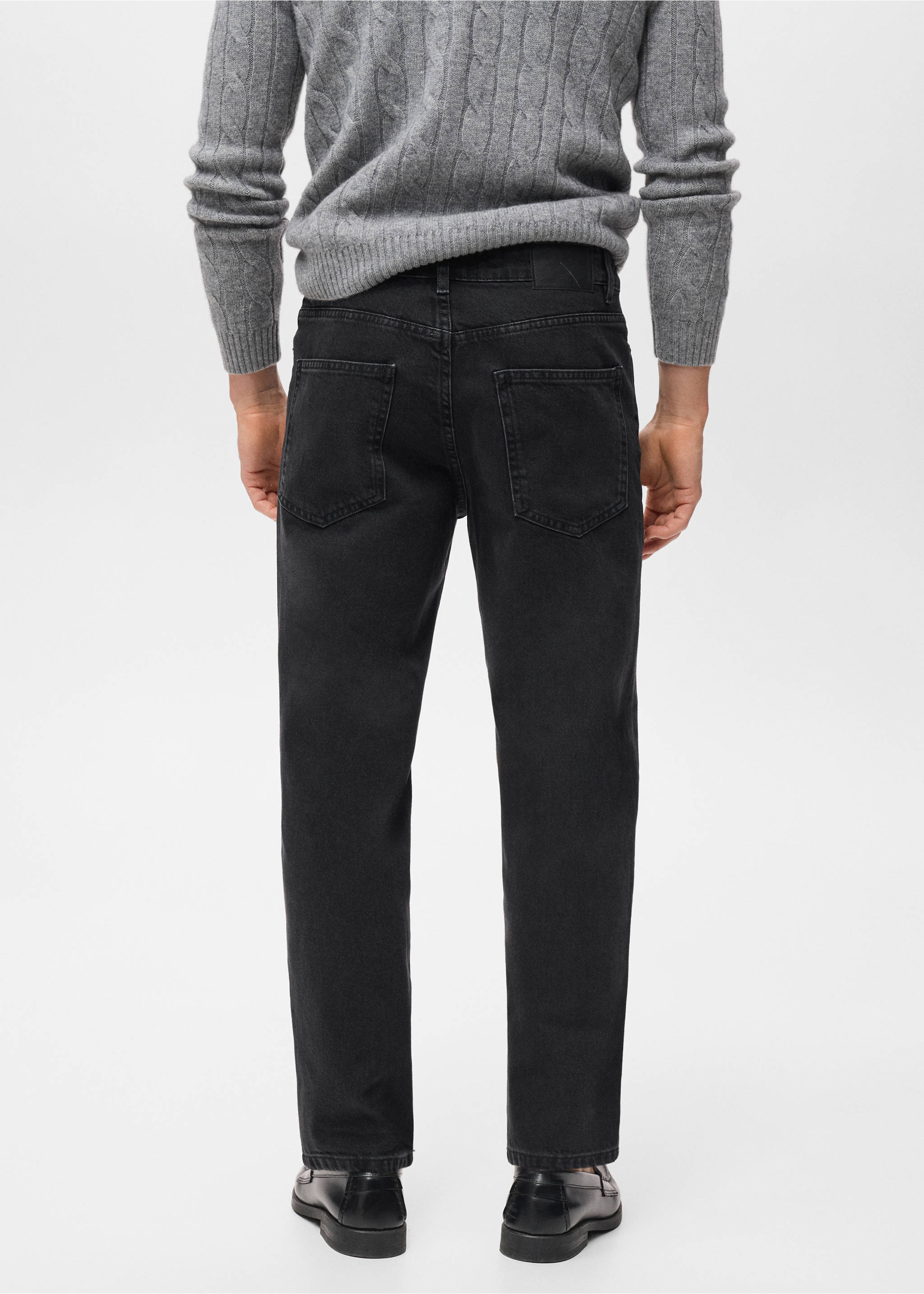 Dark grey denim trousers, back view, worn with a grey sweater., Black denim. Ref: 17025174-00.