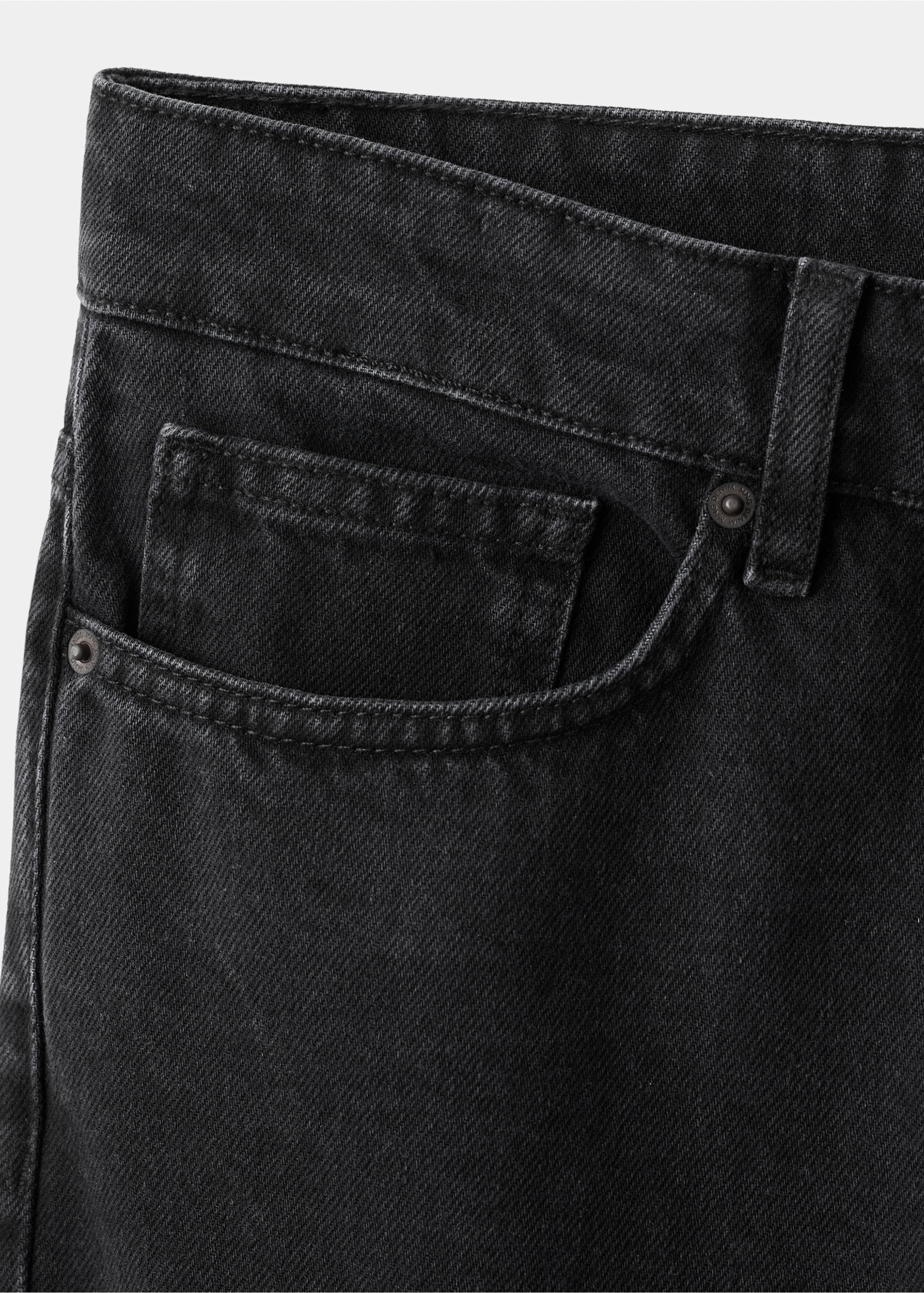Close-up of black denim trousers showing the front pocket detail., Black denim. Ref: 17025174-00.