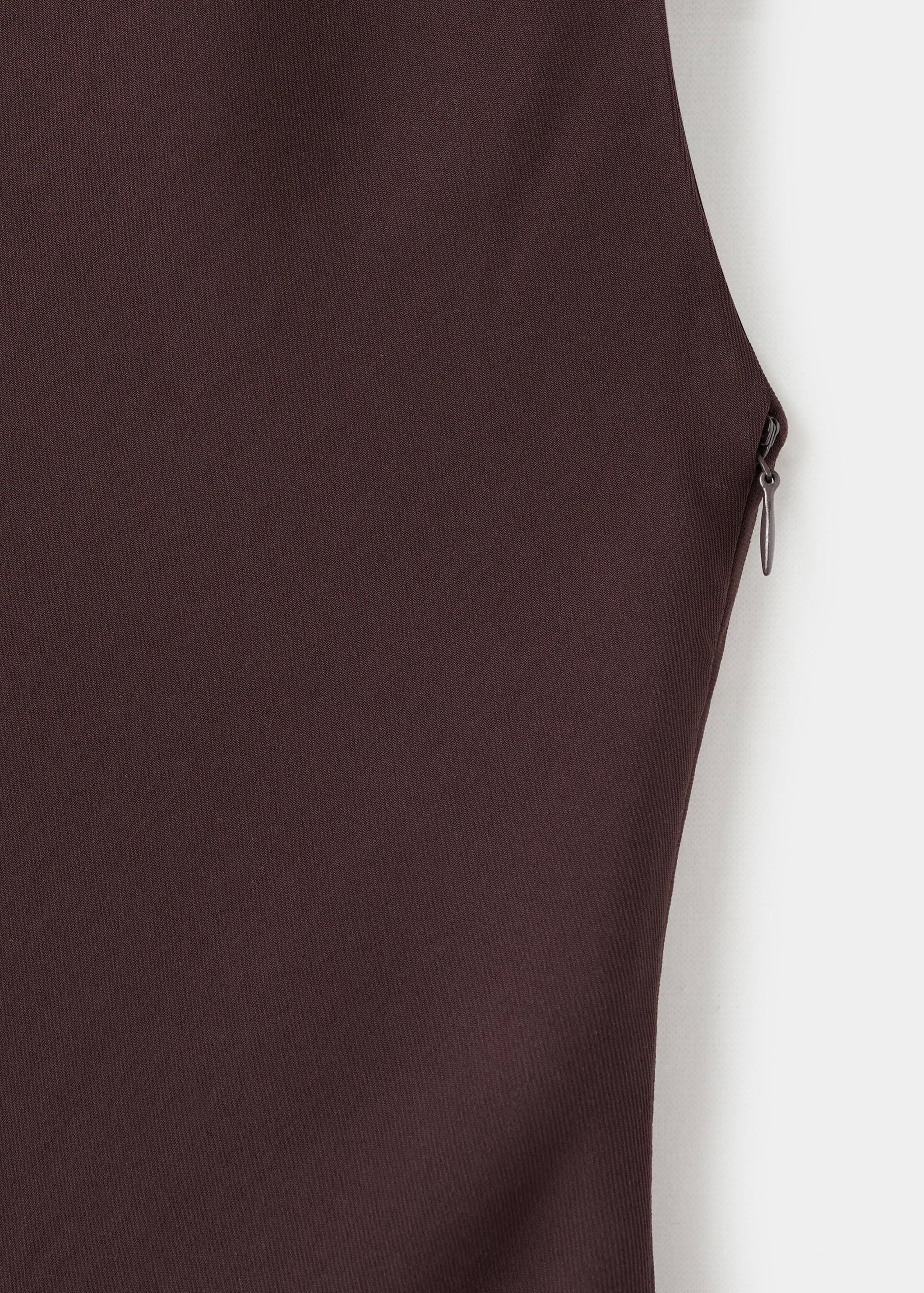 Close-up of a dark brown dress showing the side zip detail.