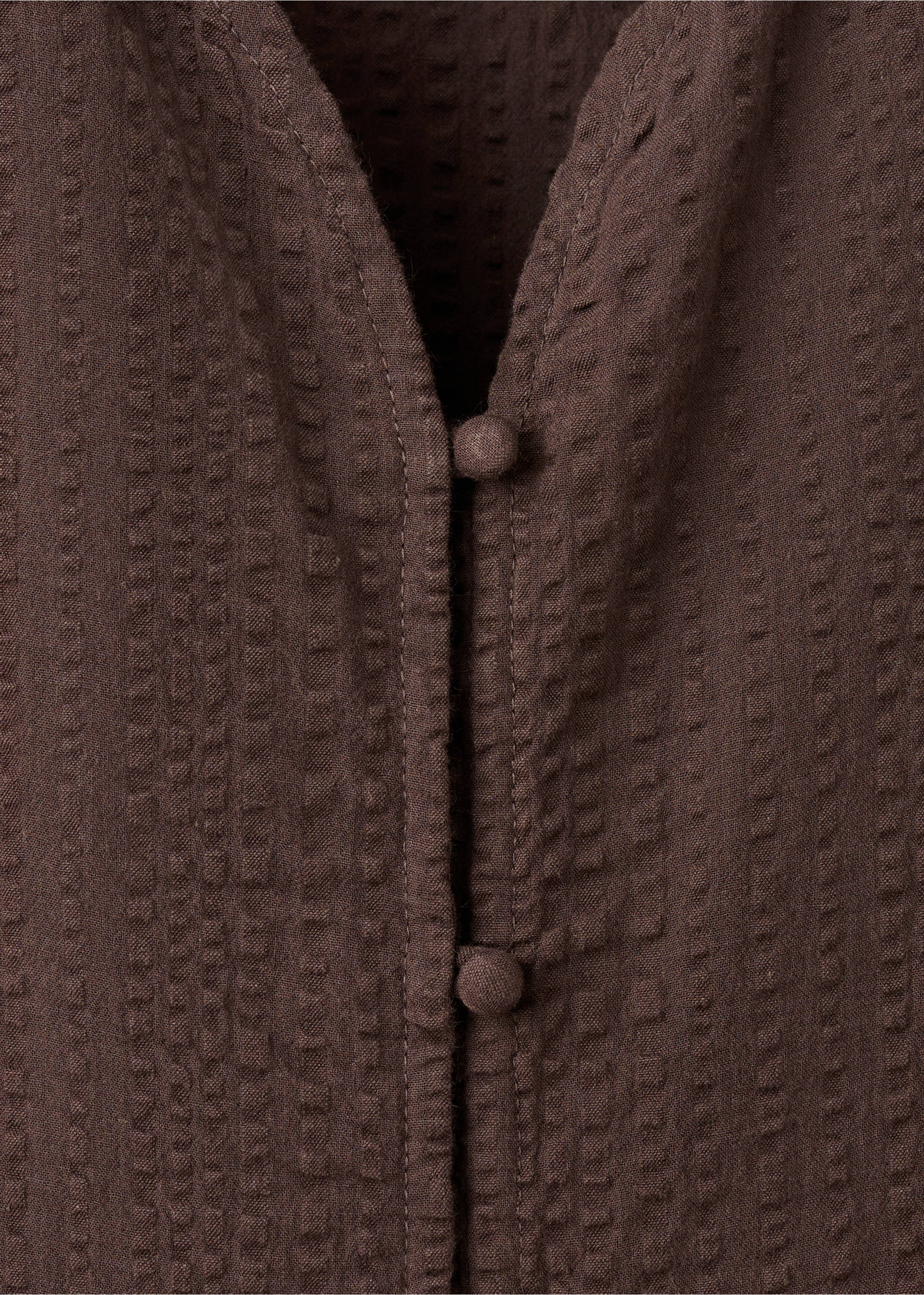 Brown textured blouse fabric close-up showing button details., Brown. Ref: 17026337-00.