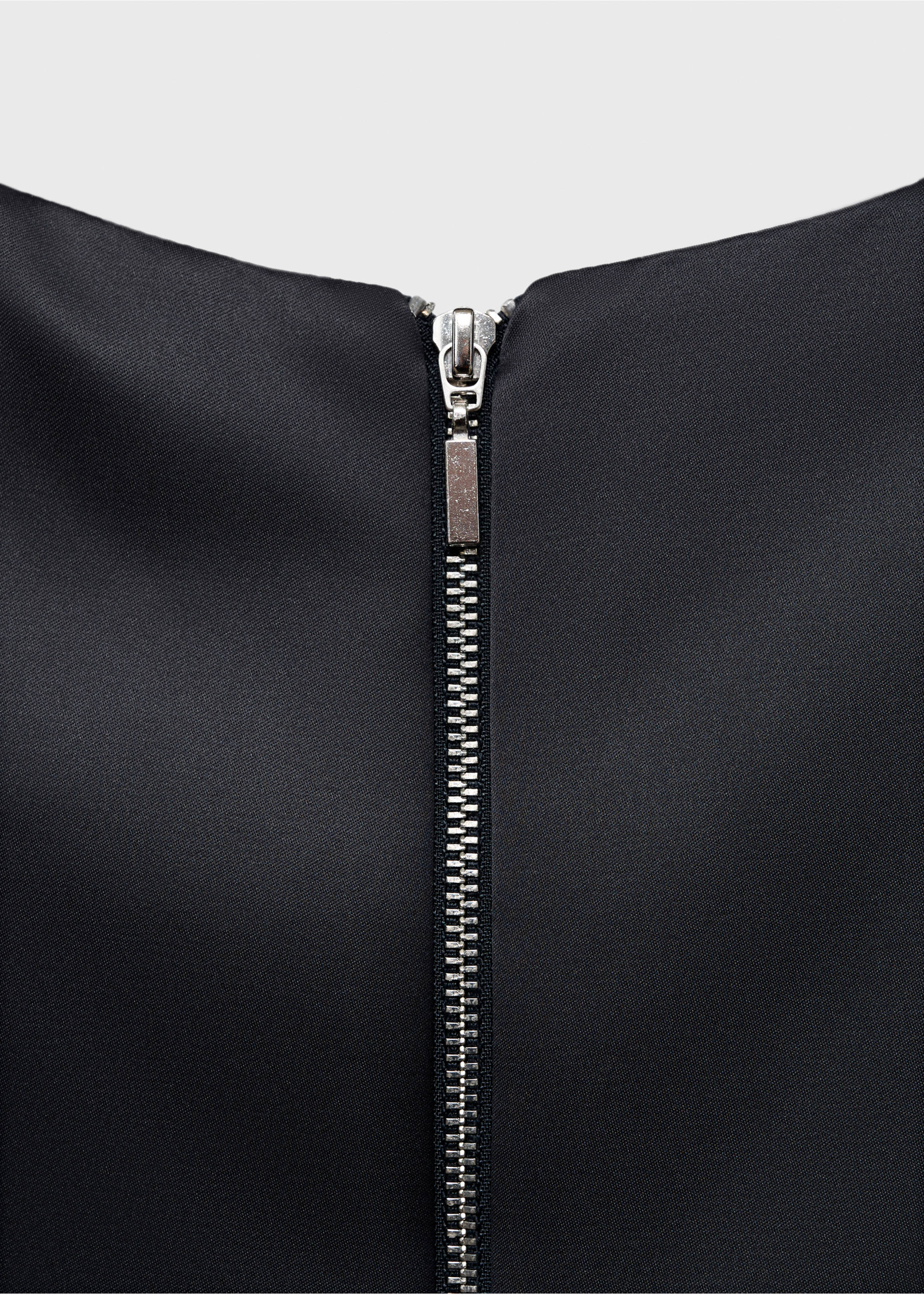 Close-up of the back zip closure on a black dress., Charcoal. Ref: 17026357-00.