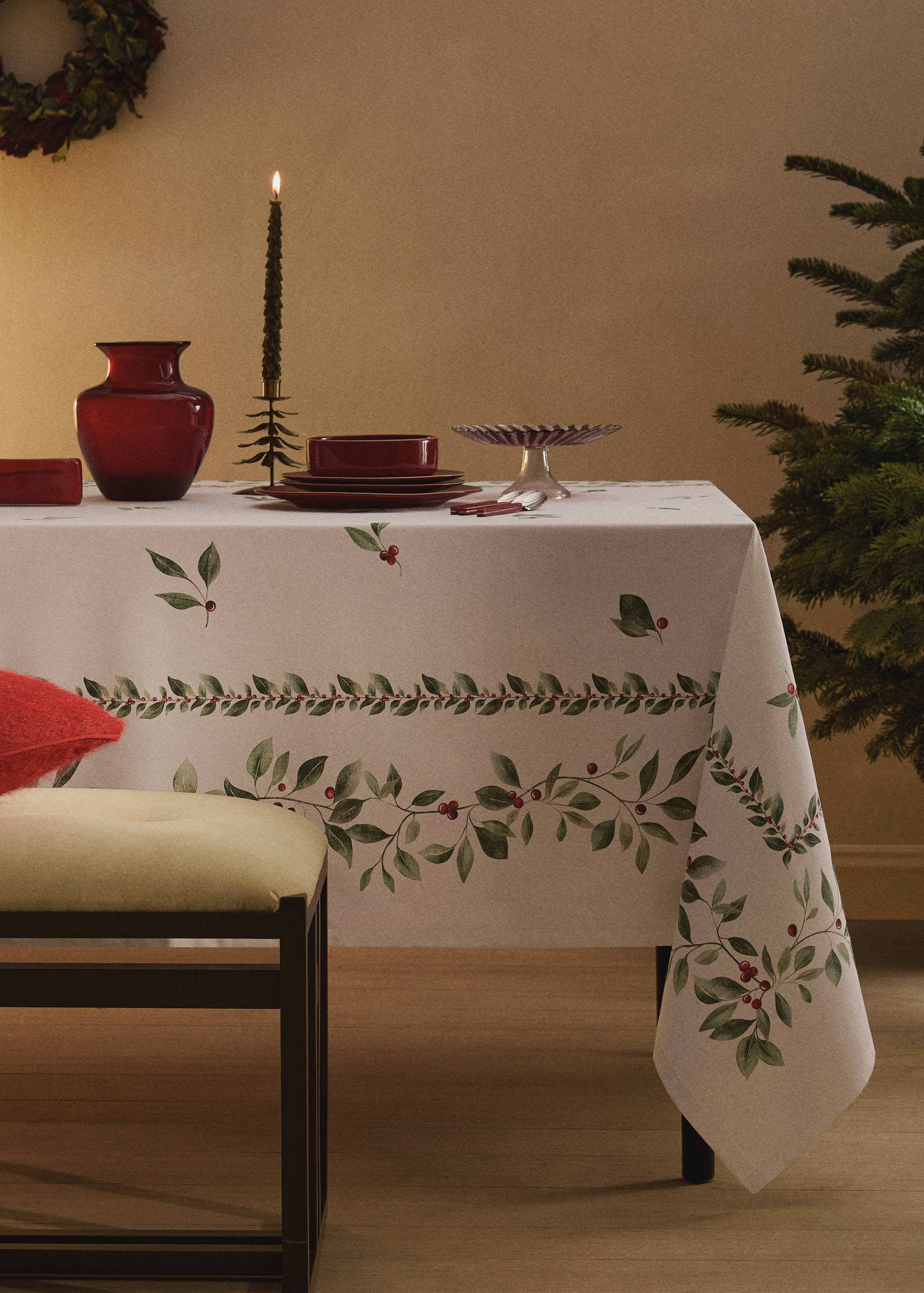 Cream tablecloth with a green leaf and red berry botanical border.