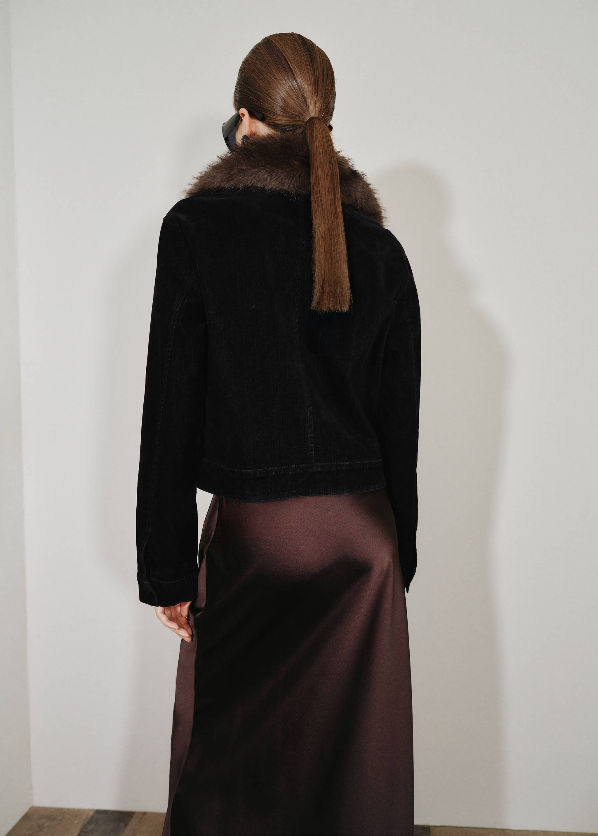 Black cropped jacket with brown faux-fur collar, shown from the back.