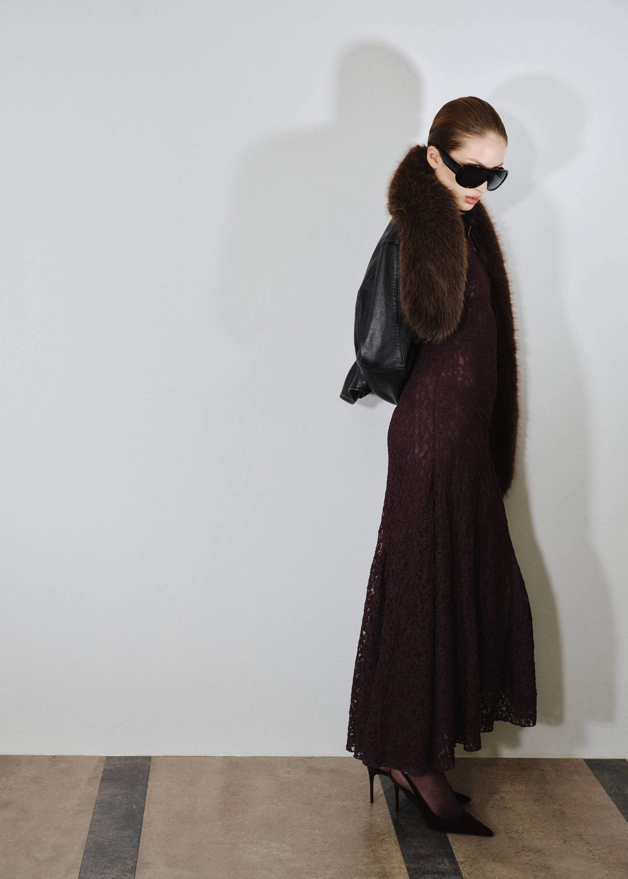 Burgundy long-sleeved lace maxi dress worn with a brown faux-fur scarf.