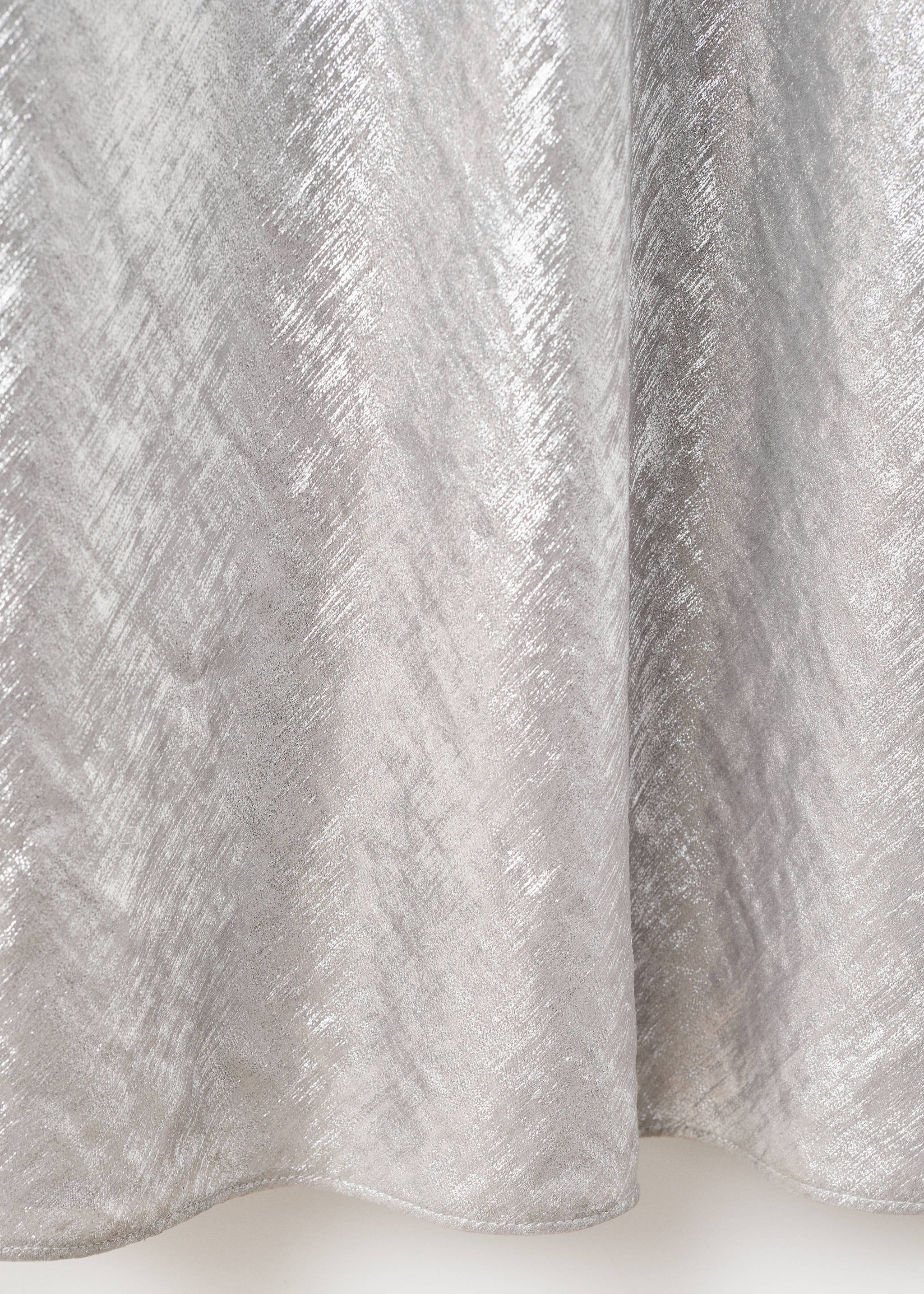 Metallic silver dress detail with a textured finish.