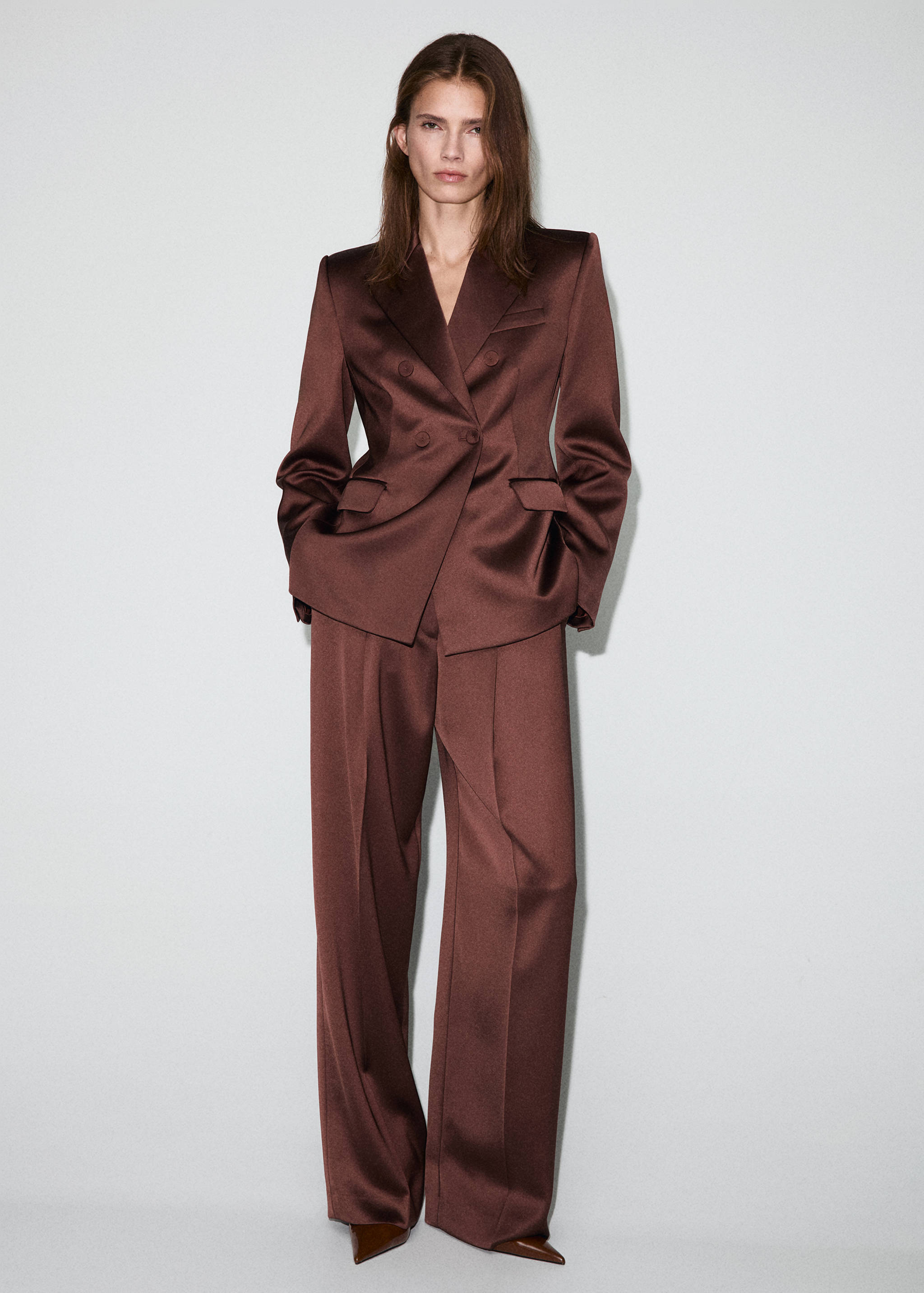 Brown satin double-breasted blazer with structured shoulders.
