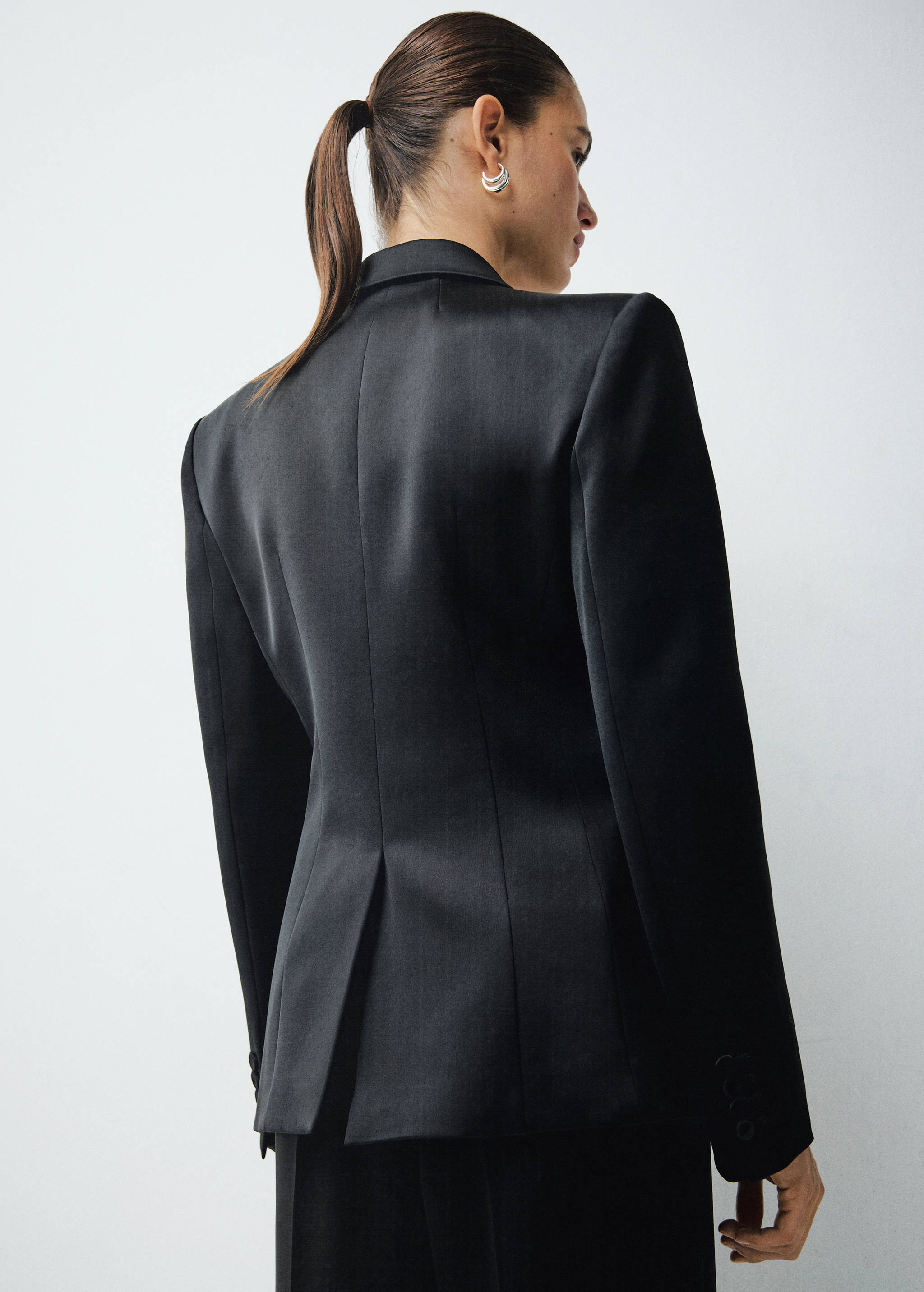 Back view of a black tailored blazer with structured shoulders.