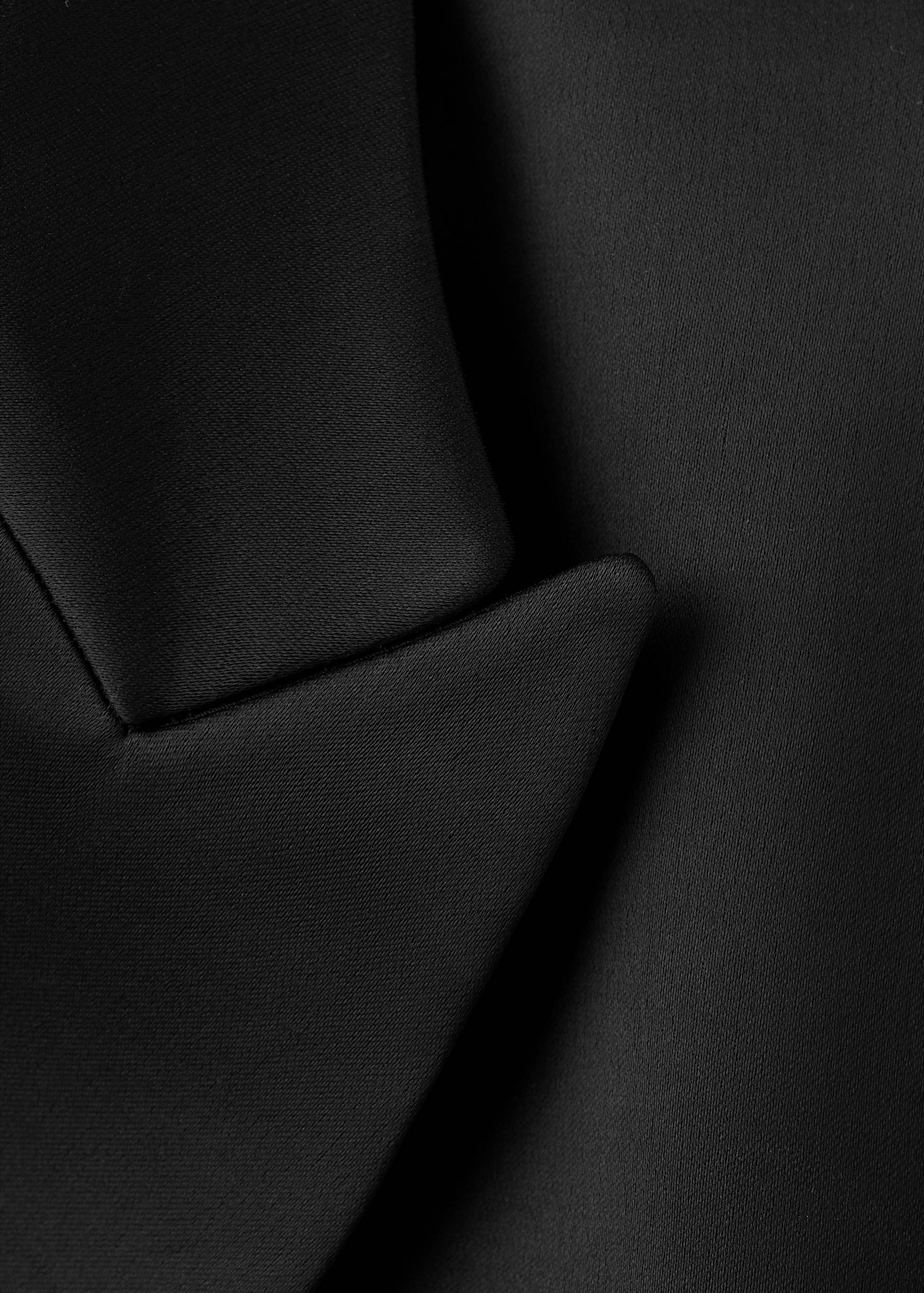 Close-up of the black blazer lapel.