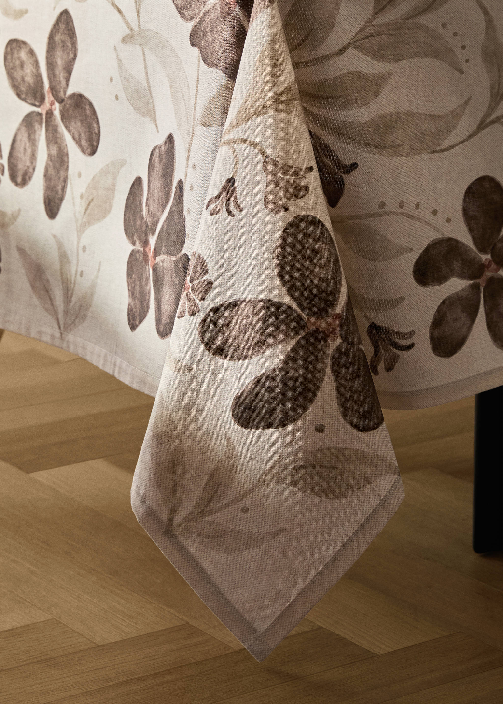 Beige tablecloth featuring a brown and taupe floral watercolor print.