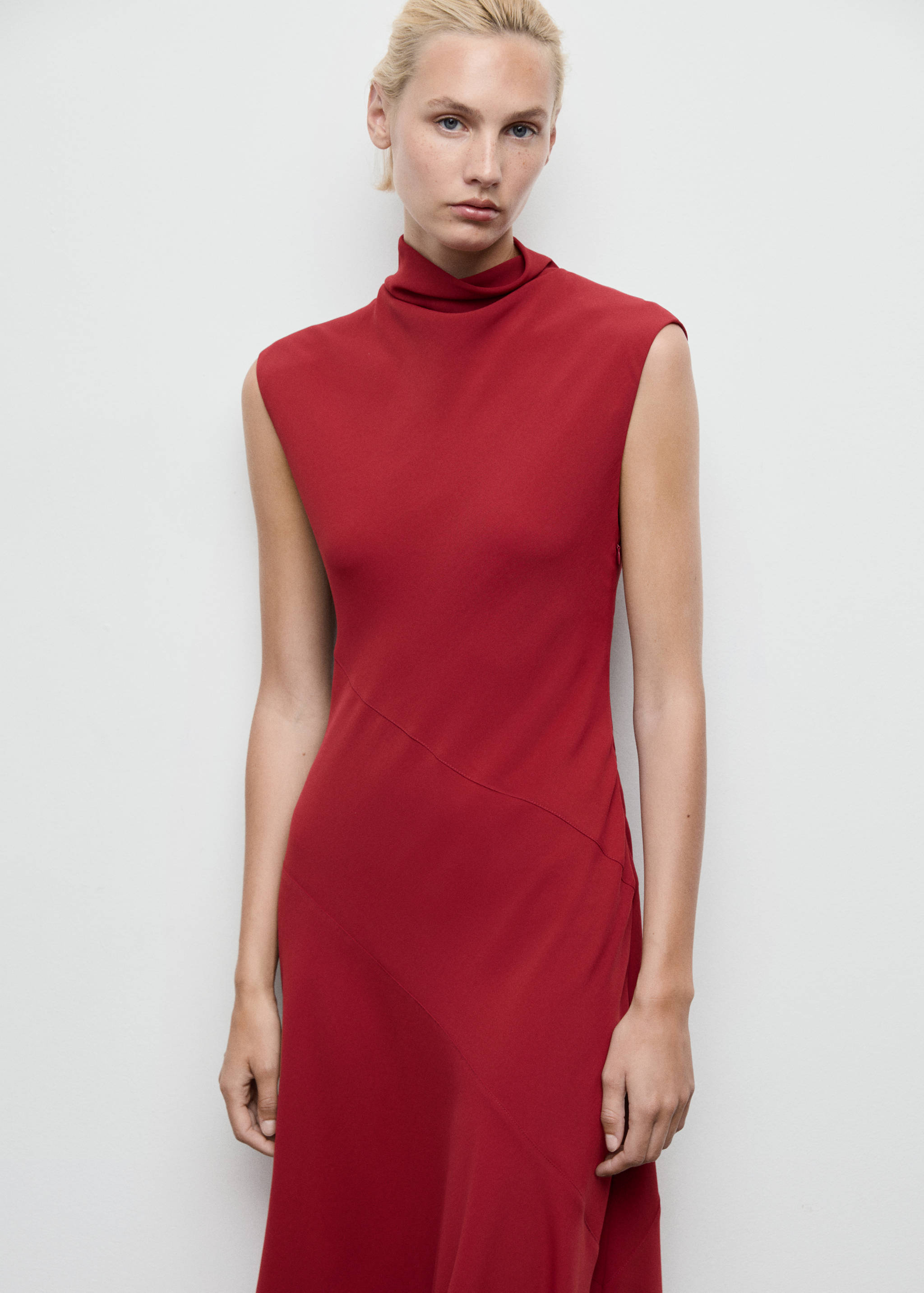 Red sleeveless midi dress featuring a high cowl neck and asymmetrical seam.