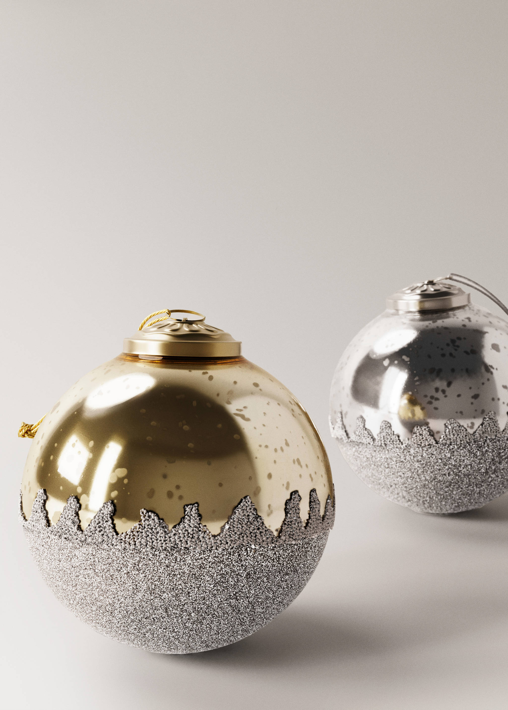 Gold Christmas ornament with a speckled glossy finish and a textured silver glitter lower half.