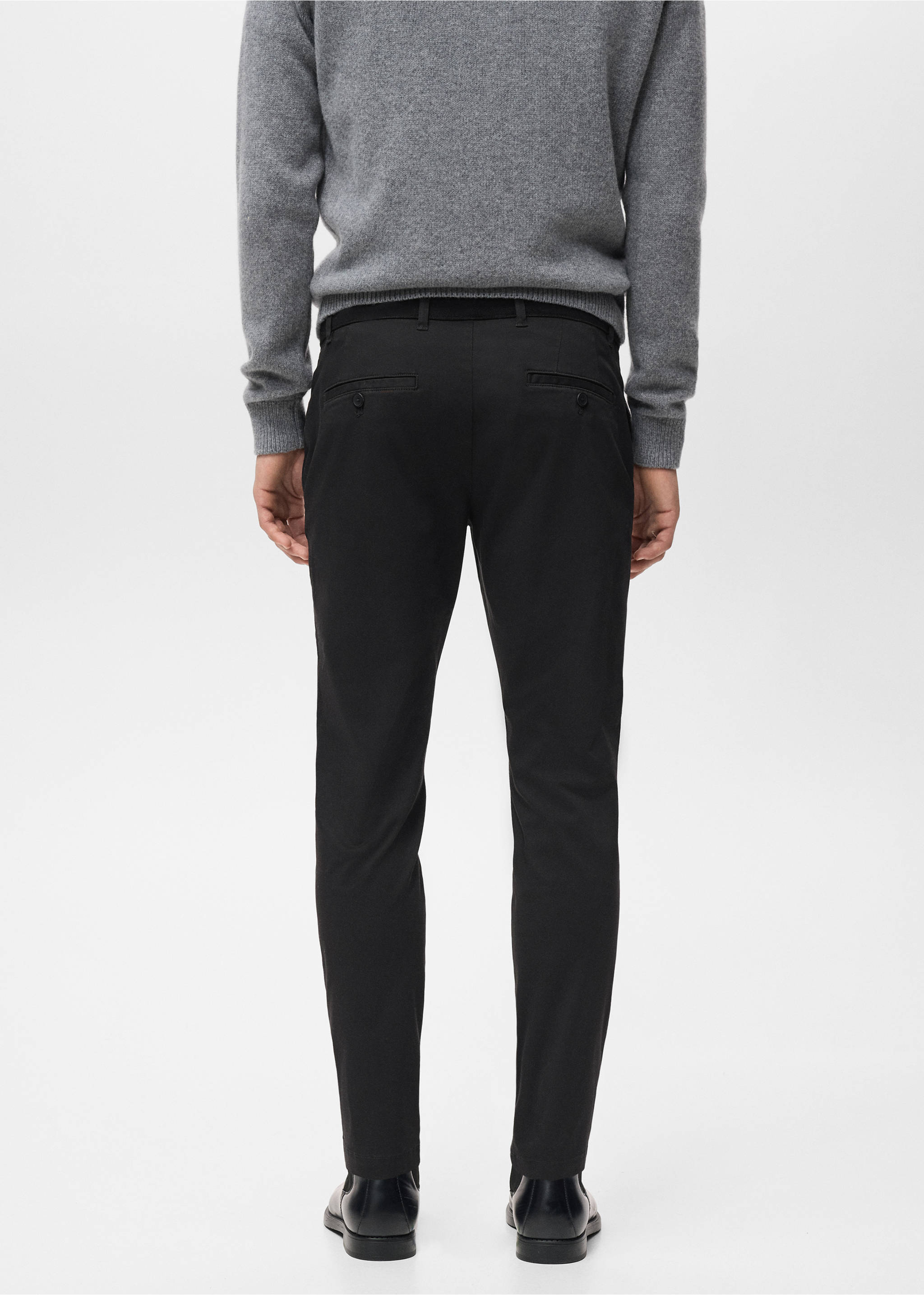 Black slim-fit trousers with rear welt pockets, shown from the back., Black. Ref: 17041144-00.