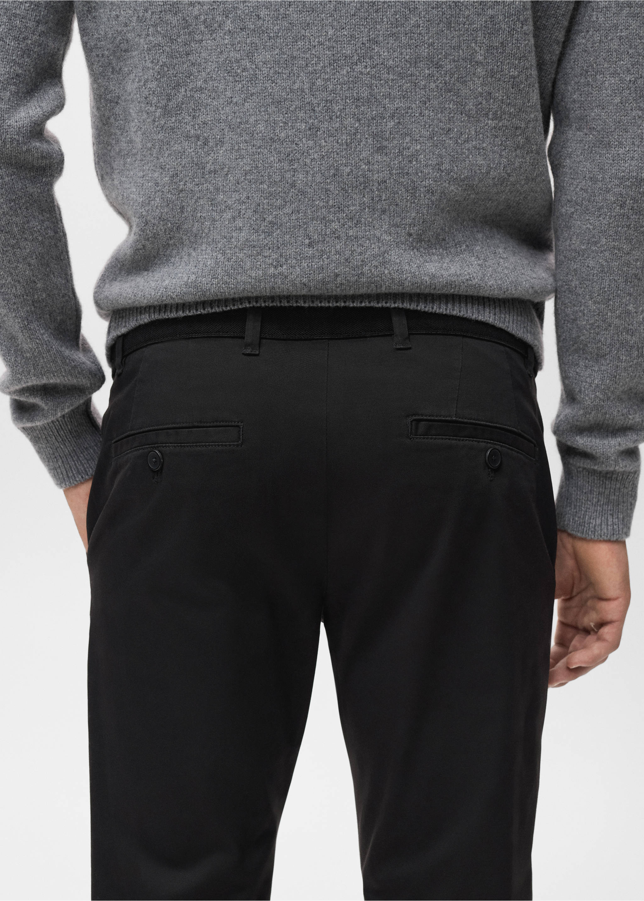Back view of black trousers with buttoned welt pockets, paired with a grey jumper., Black. Ref: 17041144-00.