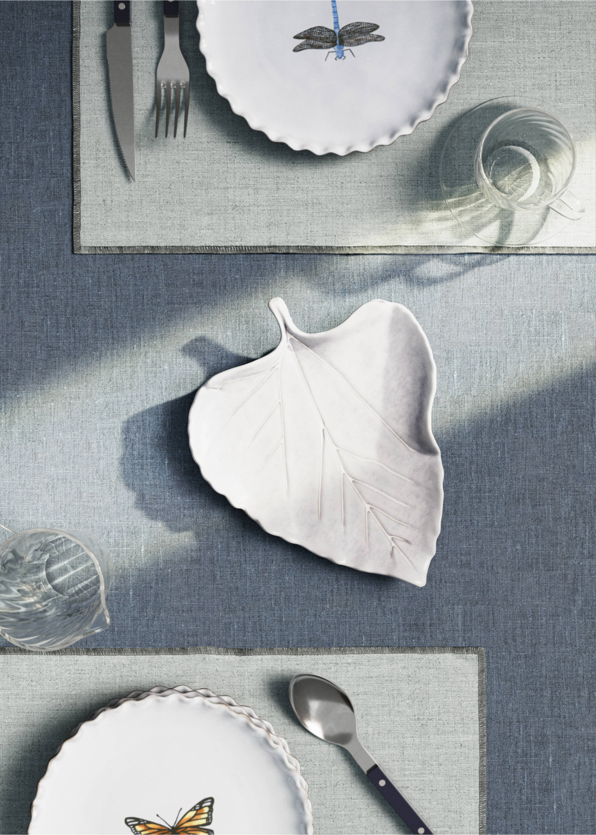 White leaf-shaped ceramic serving platter on a table setting., Light/Pastel Grey. Ref: 17042034-00.