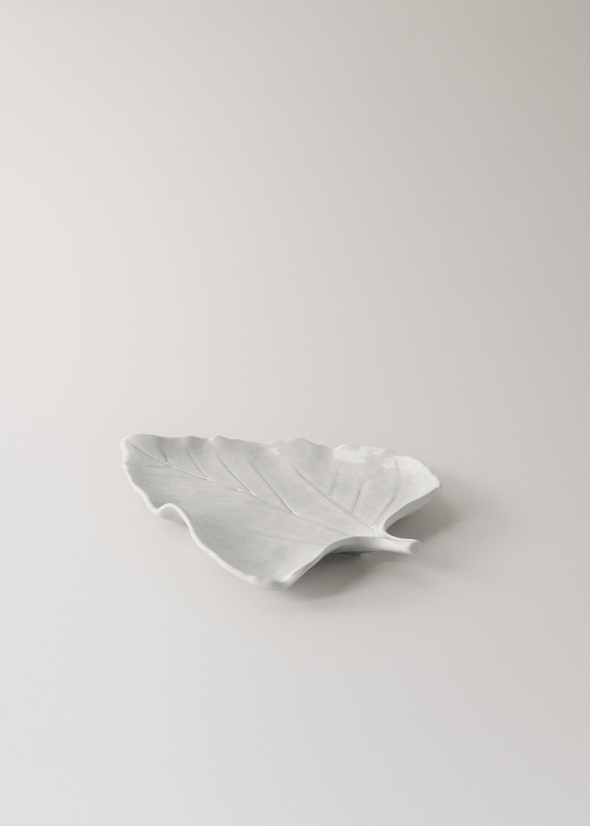 White leaf-shaped ceramic serving dish with embossed vein pattern.