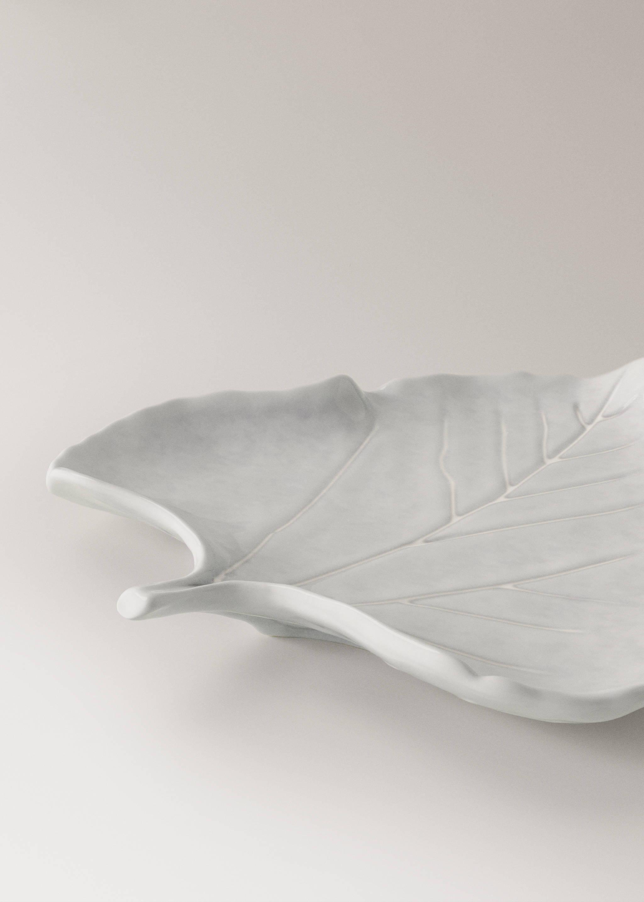 White leaf-shaped ceramic serving dish with embossed vein details.