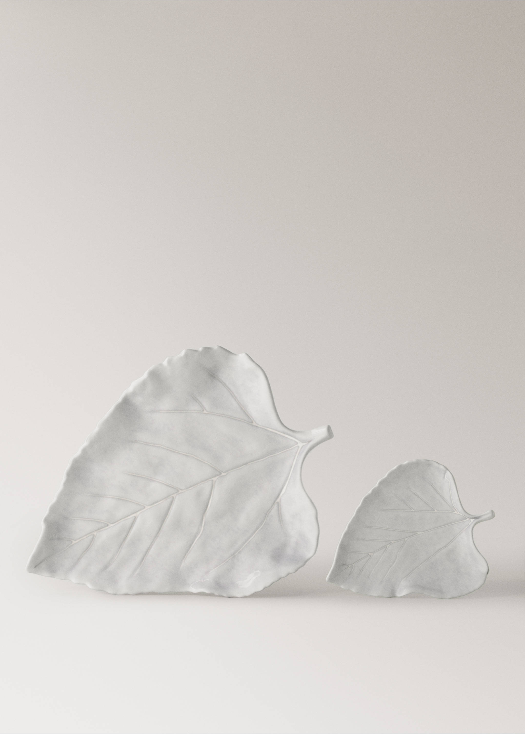 Two white leaf-shaped ceramic serving bowls with embossed vein detail., Light/Pastel Grey. Ref: 17042034-00.