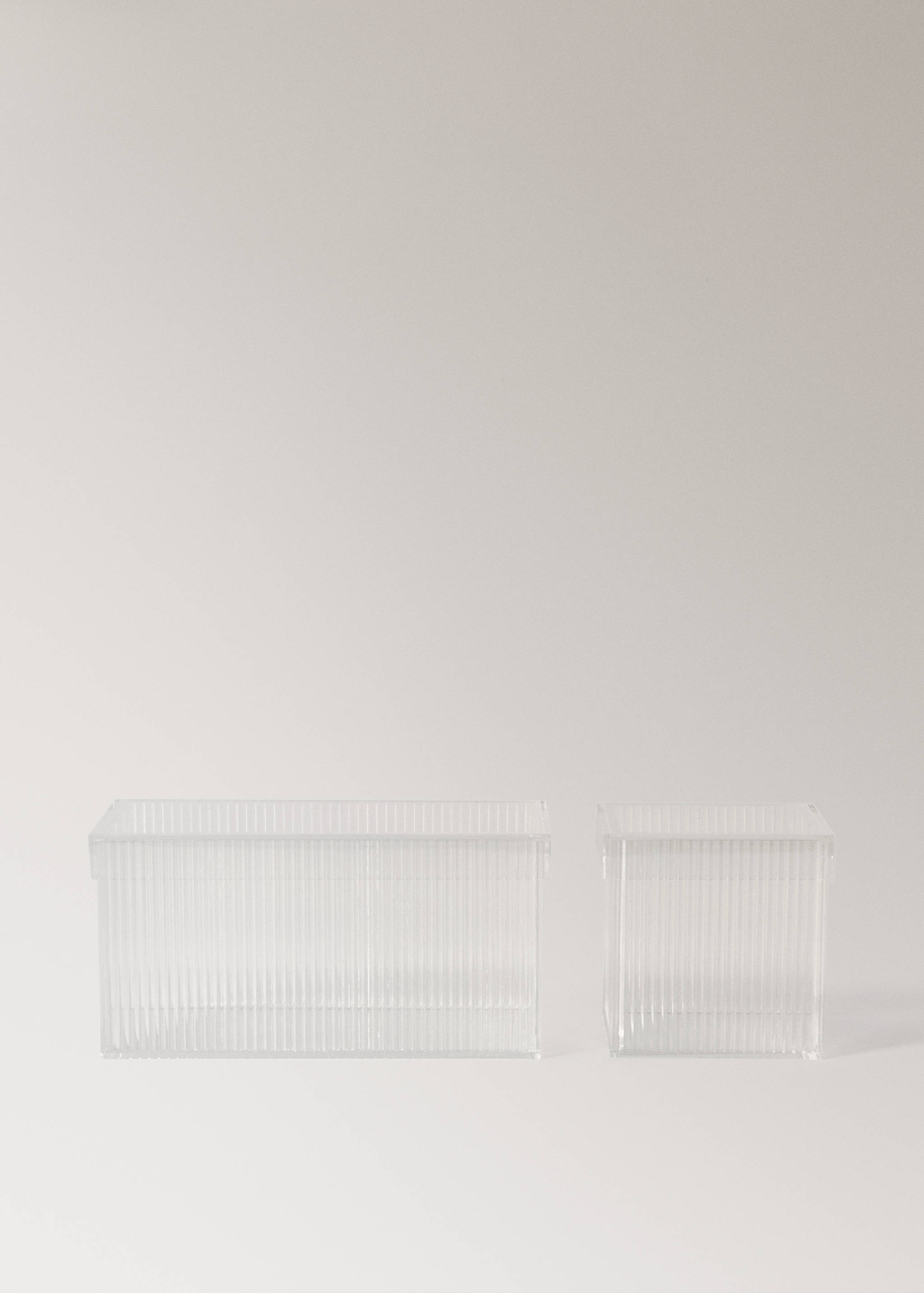 Two transparent ribbed acrylic storage boxes with matching lids.
