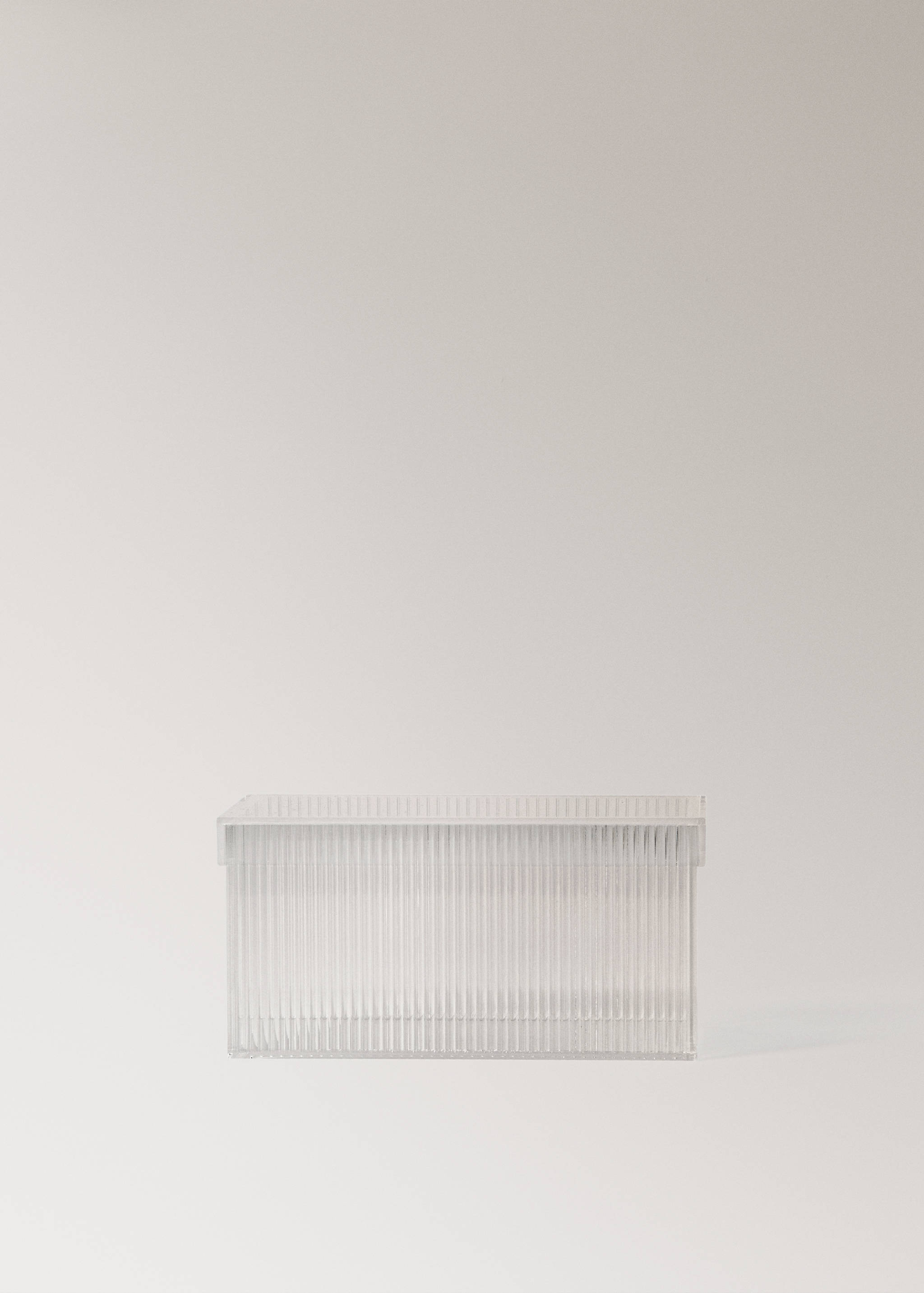 Clear plastic storage box with a lid and vertical ribbed detailing.