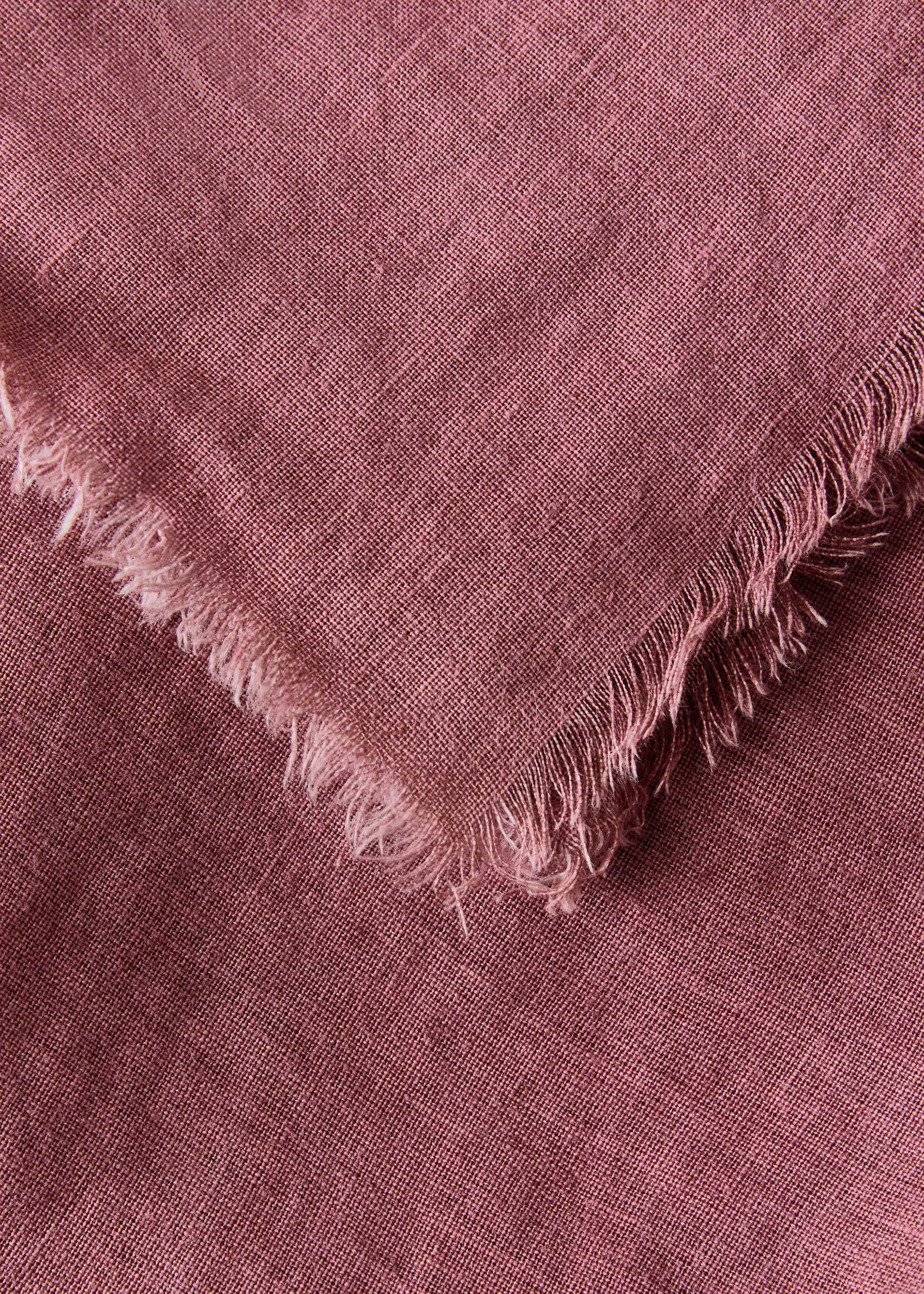 Dusty pink tablecloth detail with a frayed edge