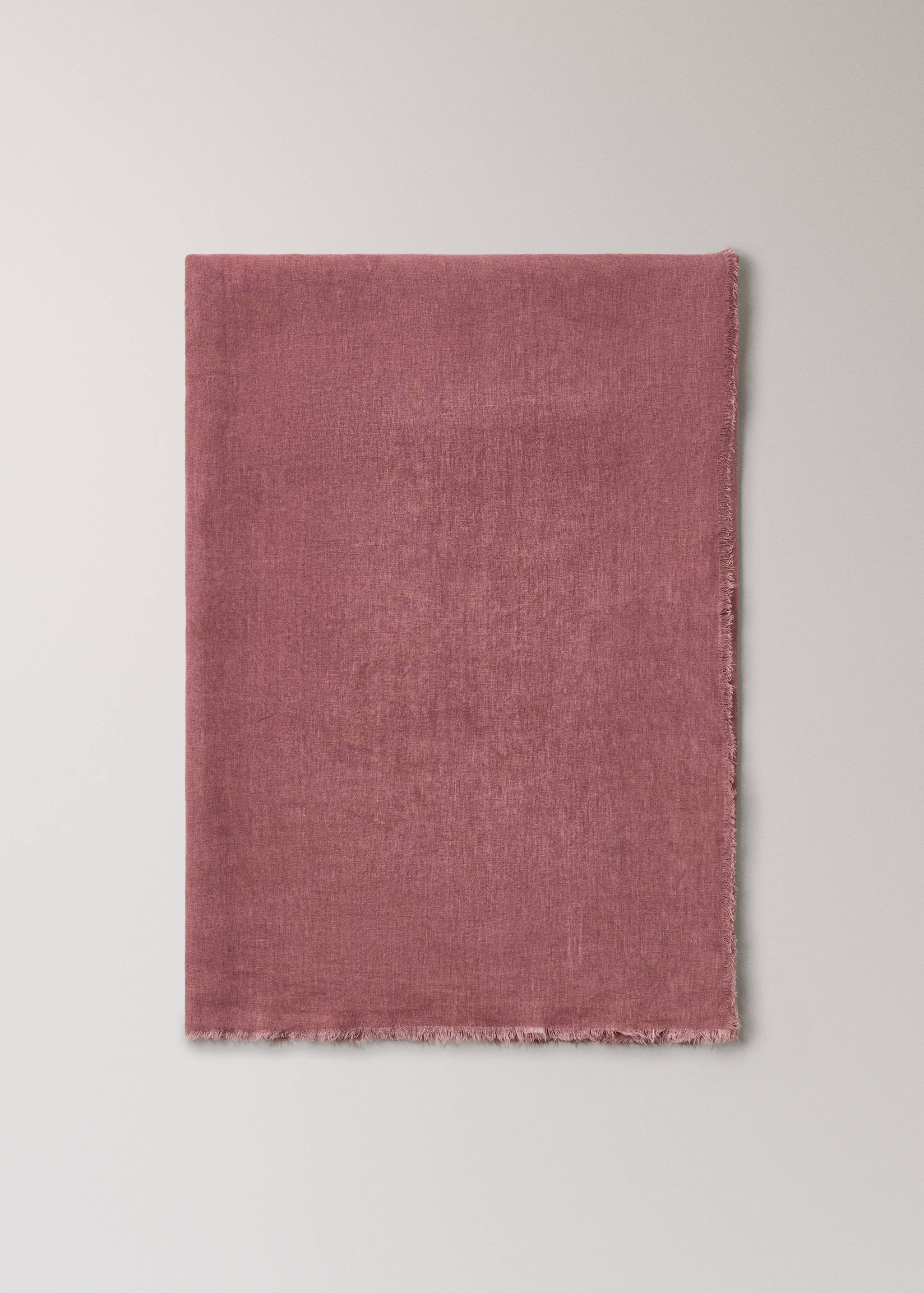 Mauve pink tablecloth with a textured weave and fringed edges.