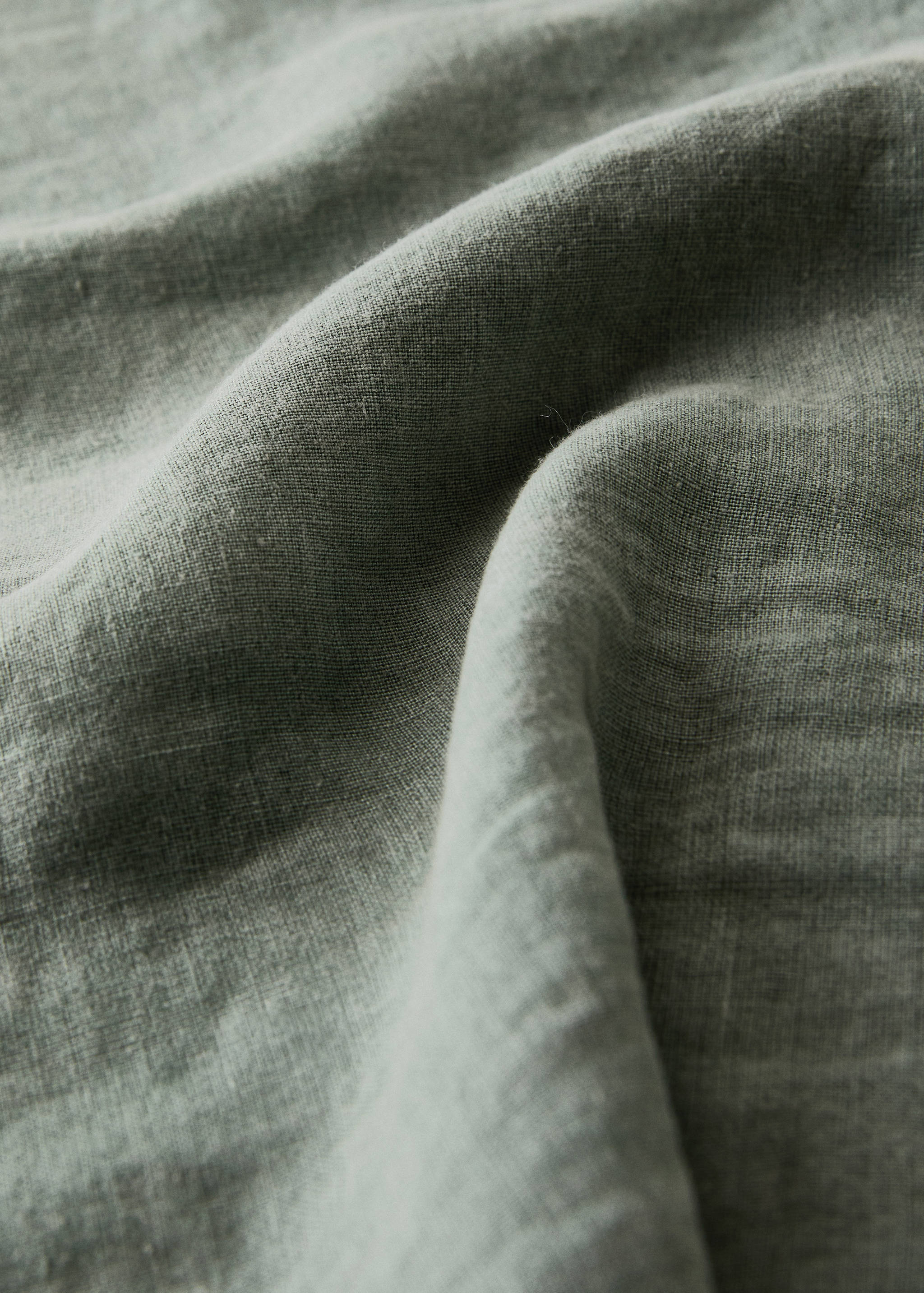 Green tablecloth texture detail.