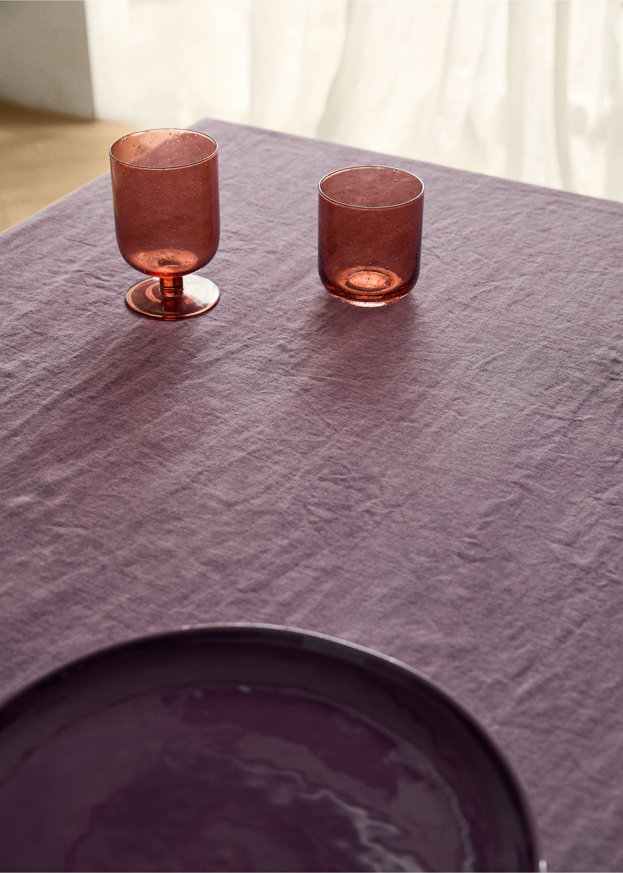 Textured muted purple tablecloth styled with matching tableware., Plum. Ref: 17043323-00.