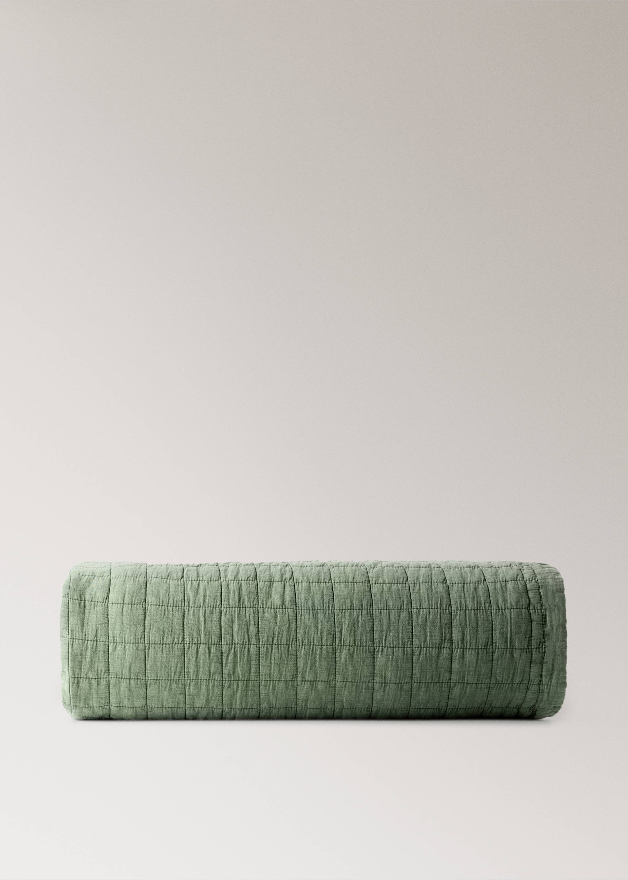 Green quilted duvet rolled up in a still life studio setting., Medium Green. Ref: 17043827-00.