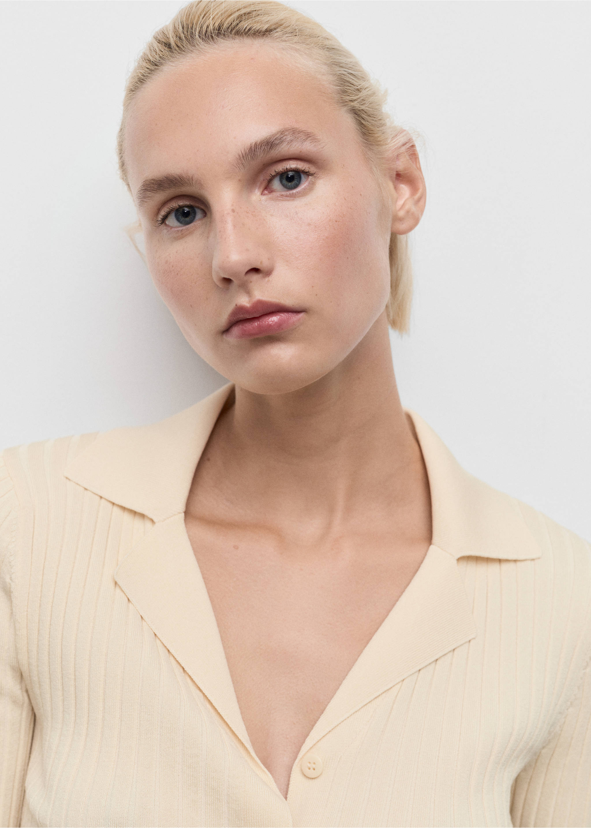Close-up of a pale yellow ribbed knit cardigan with a lapel collar., Ecru. Ref: 17044103-00.