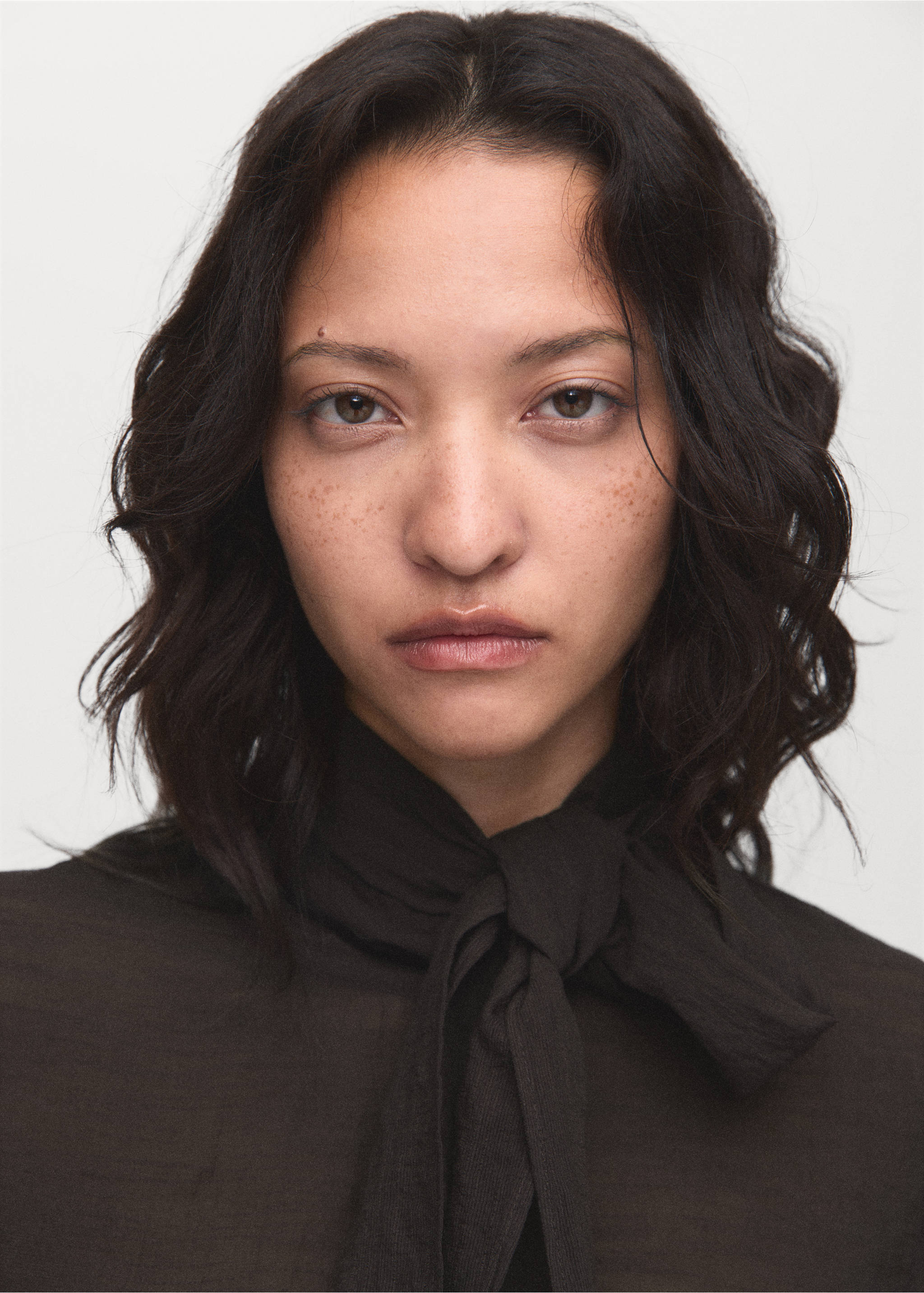 Close-up of a dark brown blouse with a high tied neckline., Chocolate. Ref: 17044138-00.