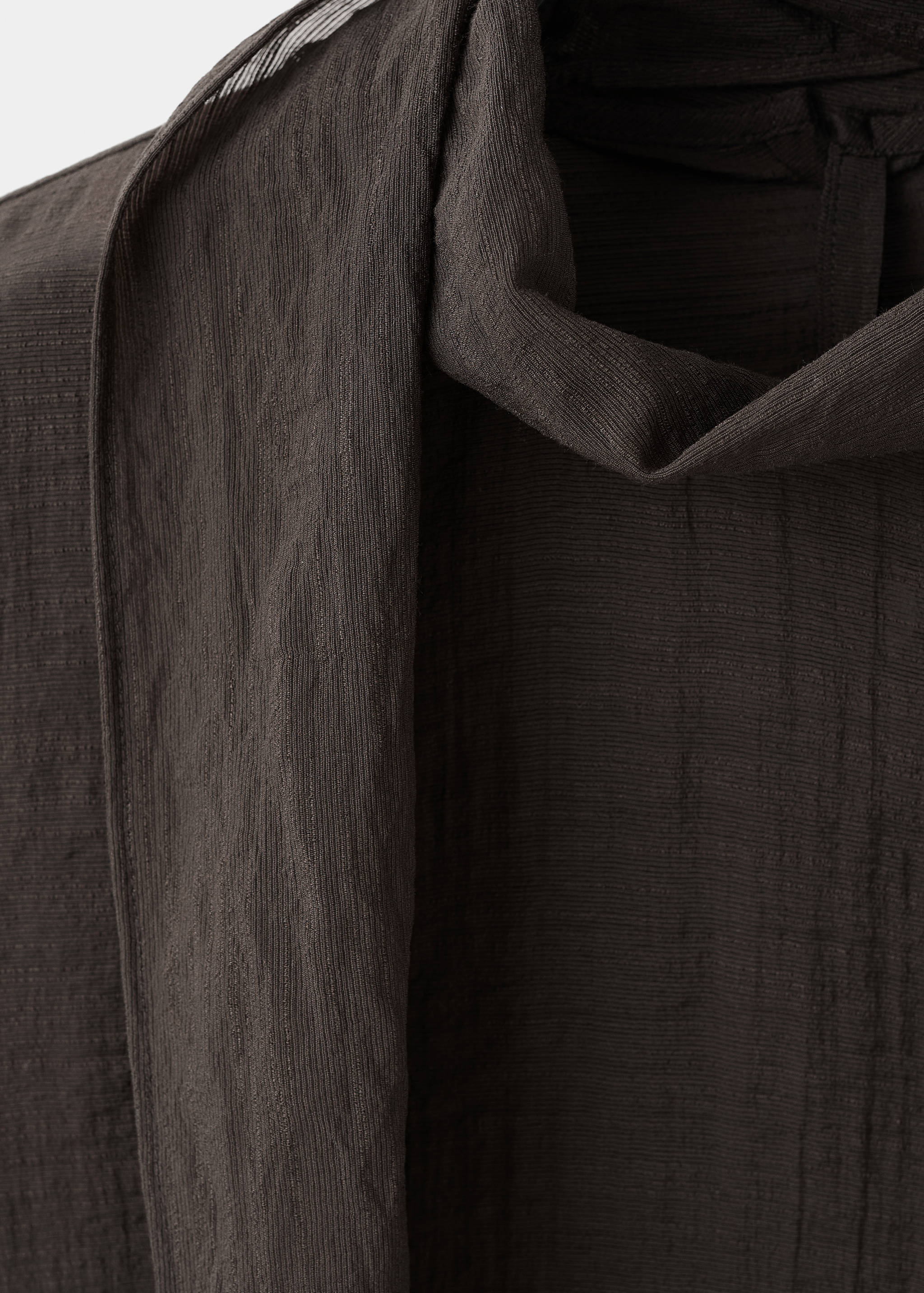 Dark brown textured blouse fabric detail