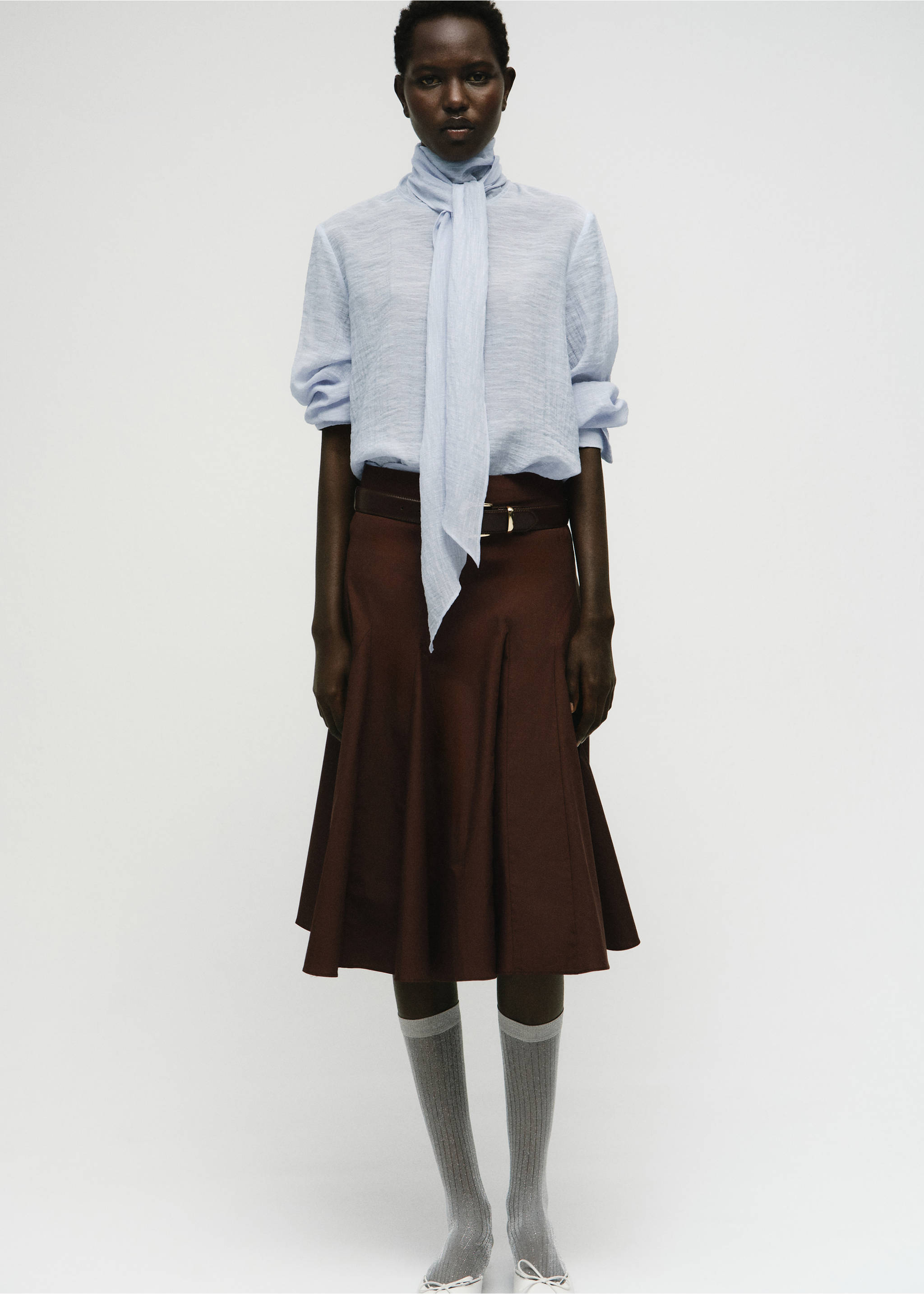 Light blue textured blouse with a tie-neck scarf, worn with a brown skirt., Sky Blue. Ref: 17044138-00.