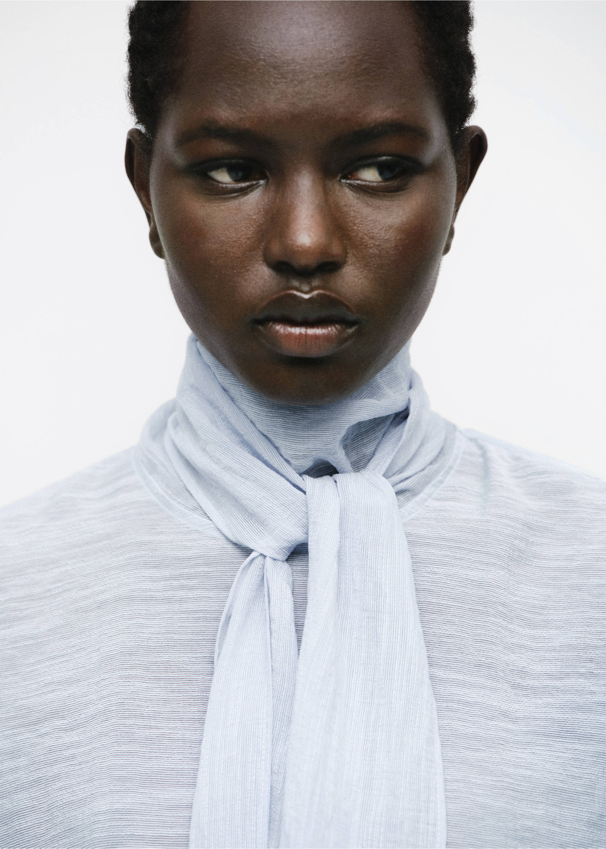 Light blue textured blouse with a high neck and front scarf tie., Sky Blue. Ref: 17044138-00.