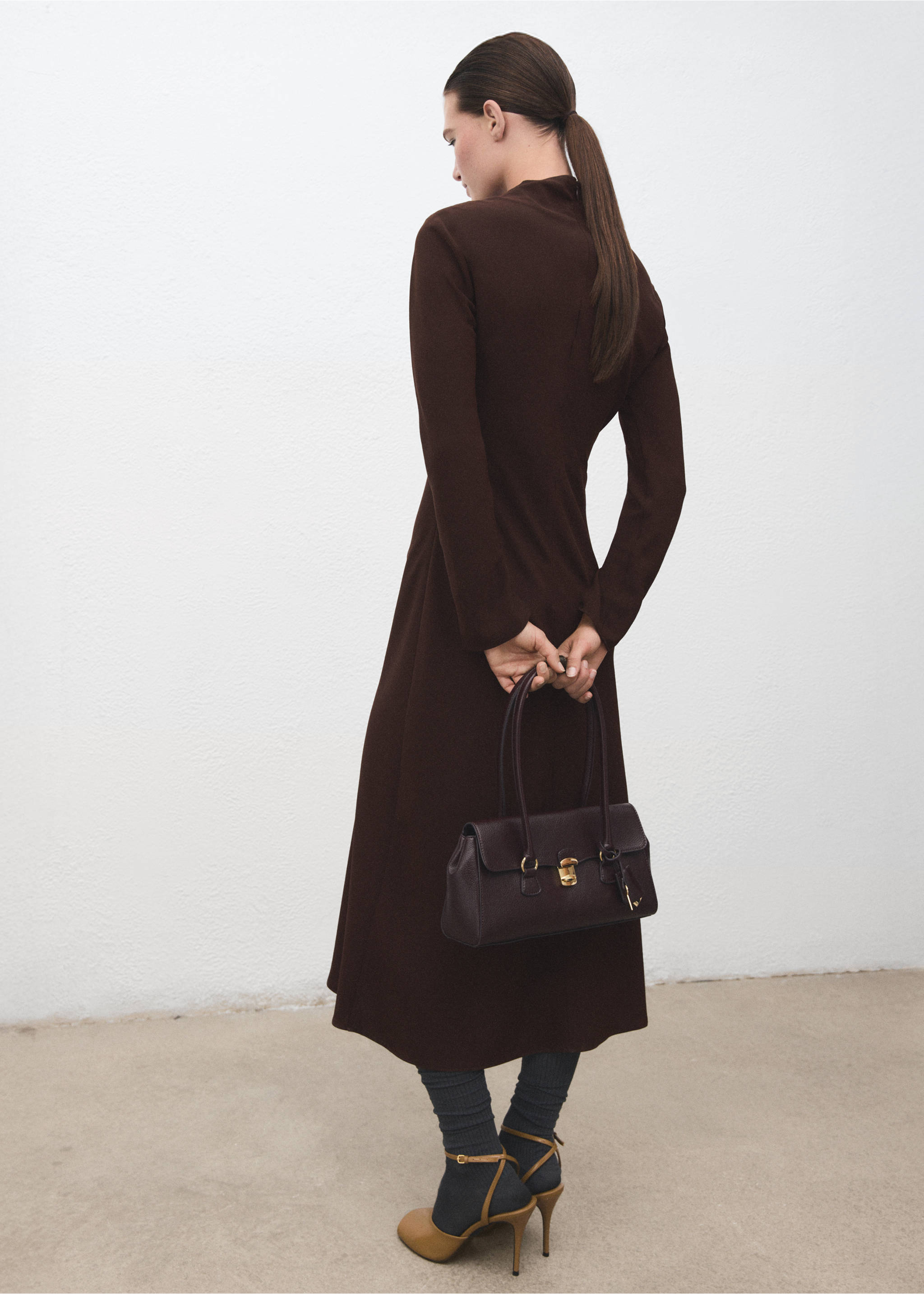 Back view of a long-sleeved dark brown midi dress held with a matching handbag., Chocolate. Ref: 17047808-00.