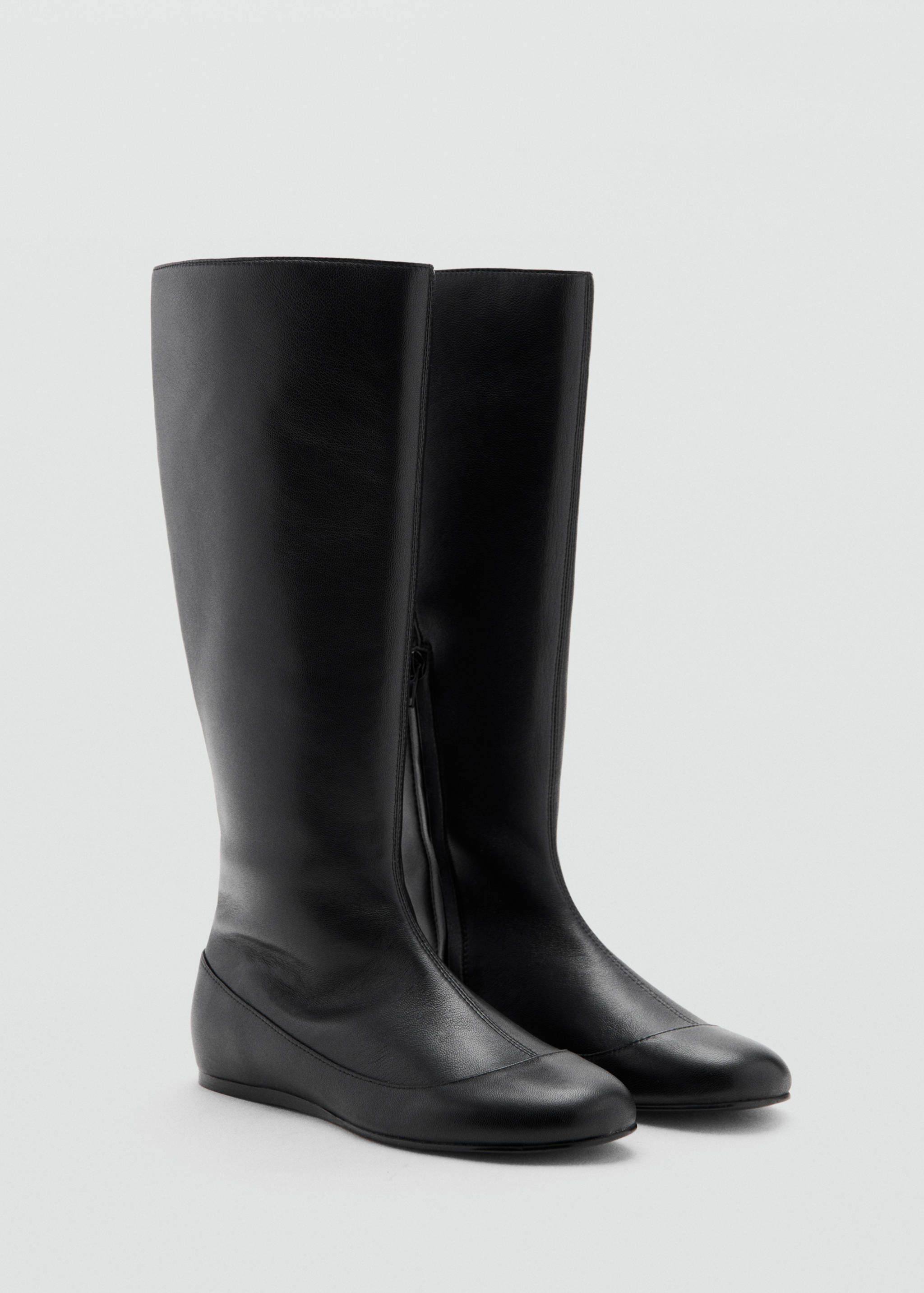 Pair of black knee-high leather boots with flat soles and rounded toes.