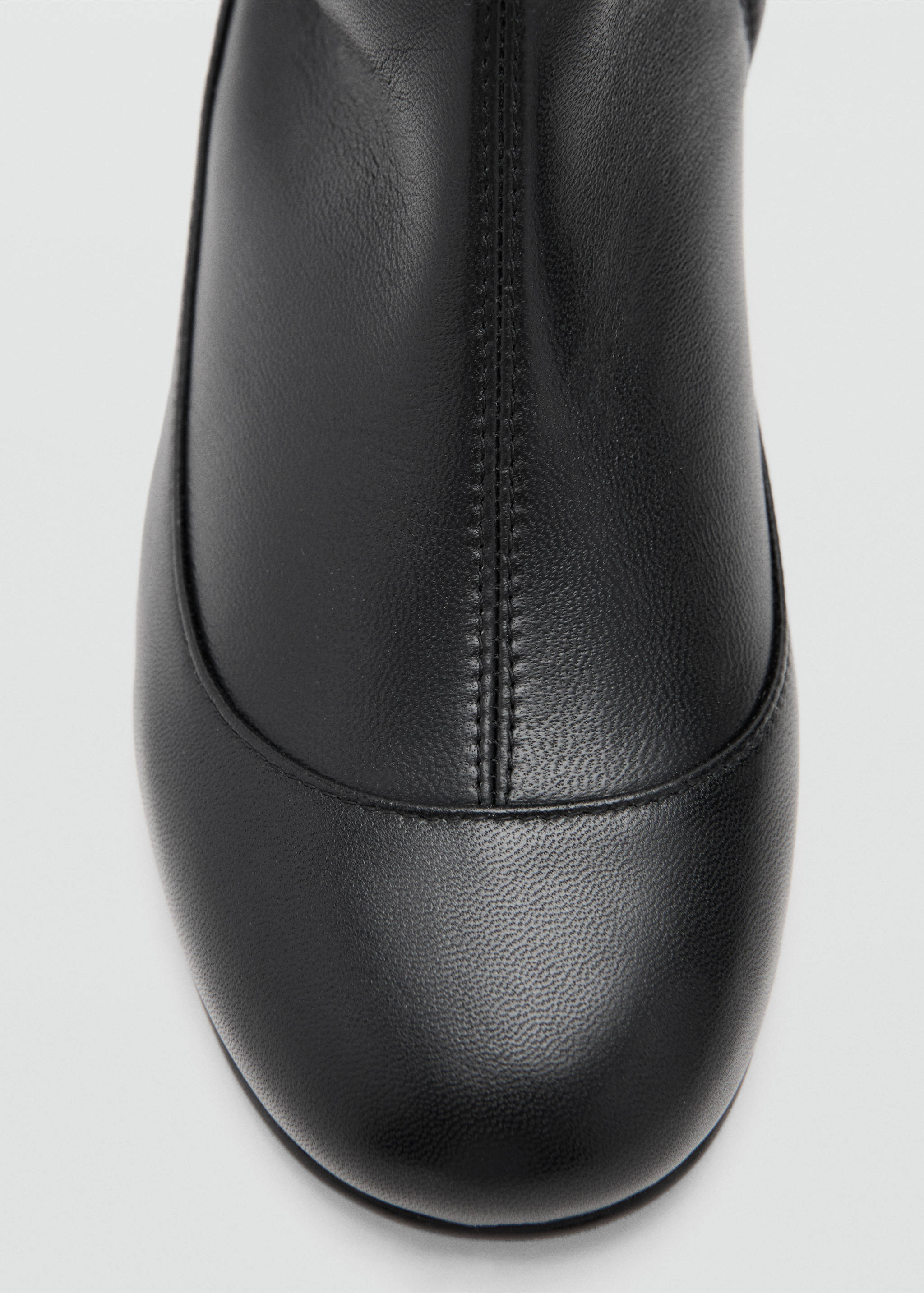 Close-up of a black leather boot with a rounded toe and central seam., Black. Ref: 17048272-00.