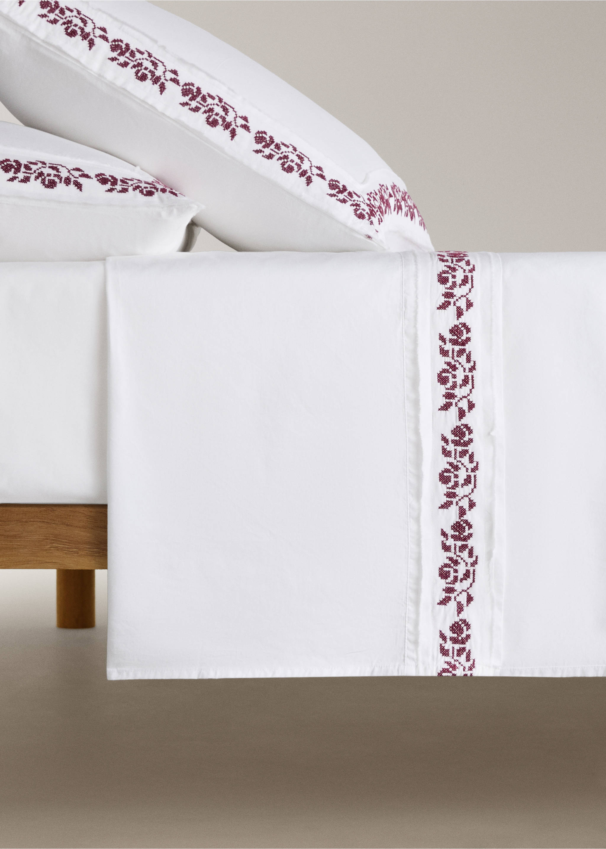 White flat sheet featuring a decorative burgundy floral embroidered border., Off White. Ref: 17048288-00.