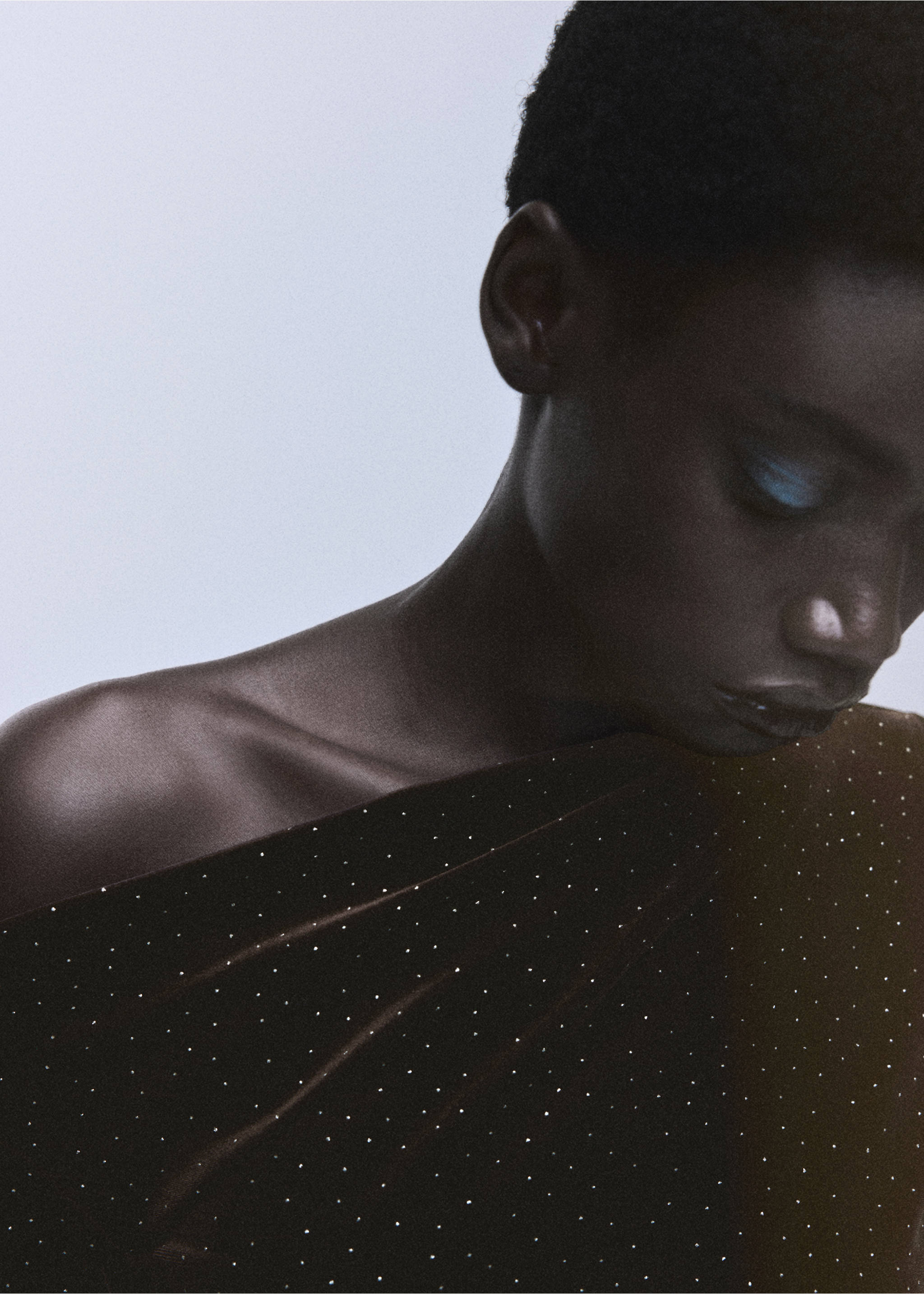 Close-up of a rhinestone-embellished velvet dress with an asymmetrical neckline., Brown. Ref: 17049111-00.