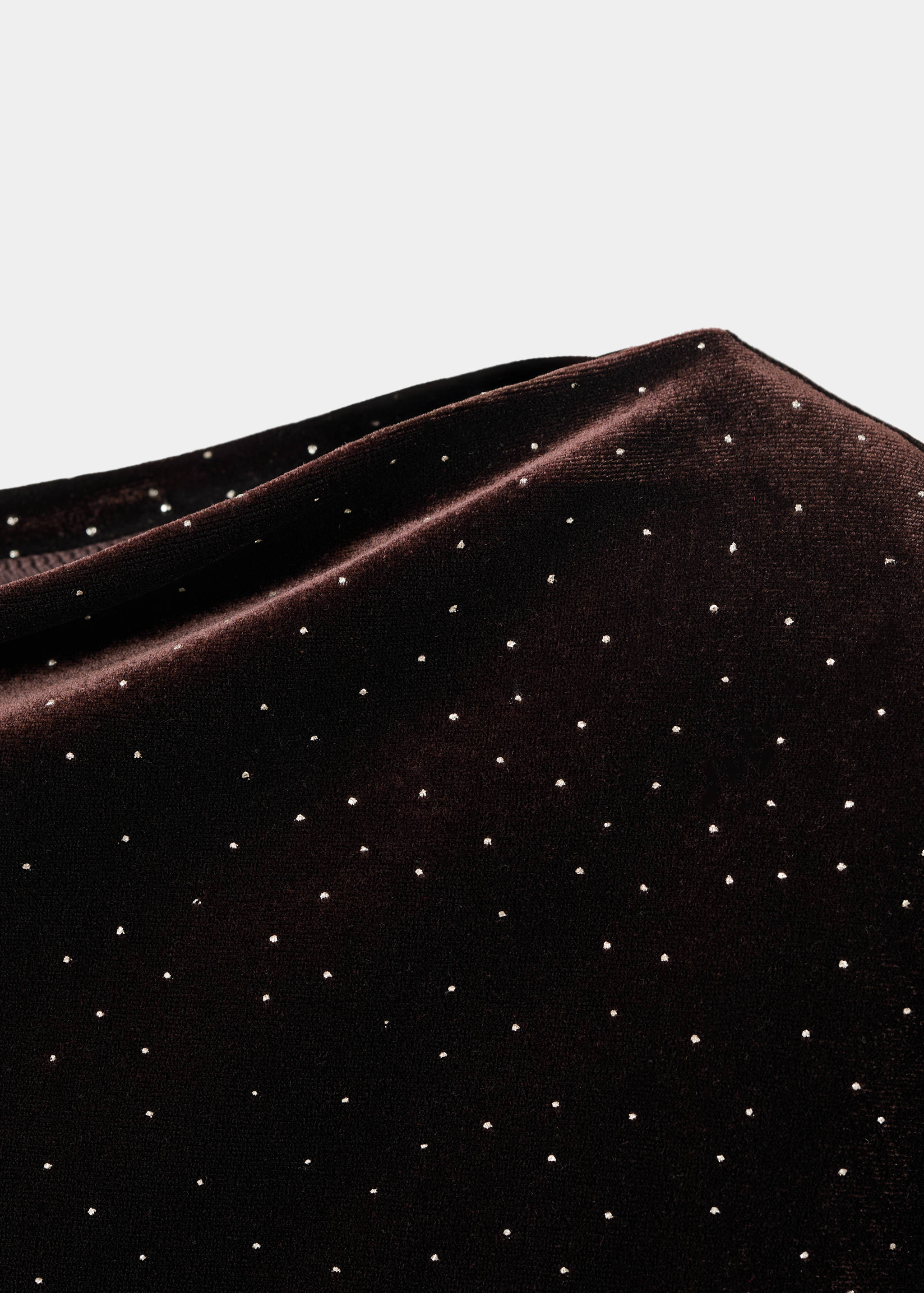 Close-up of a dark brown velvet dress with scattered silver studs.