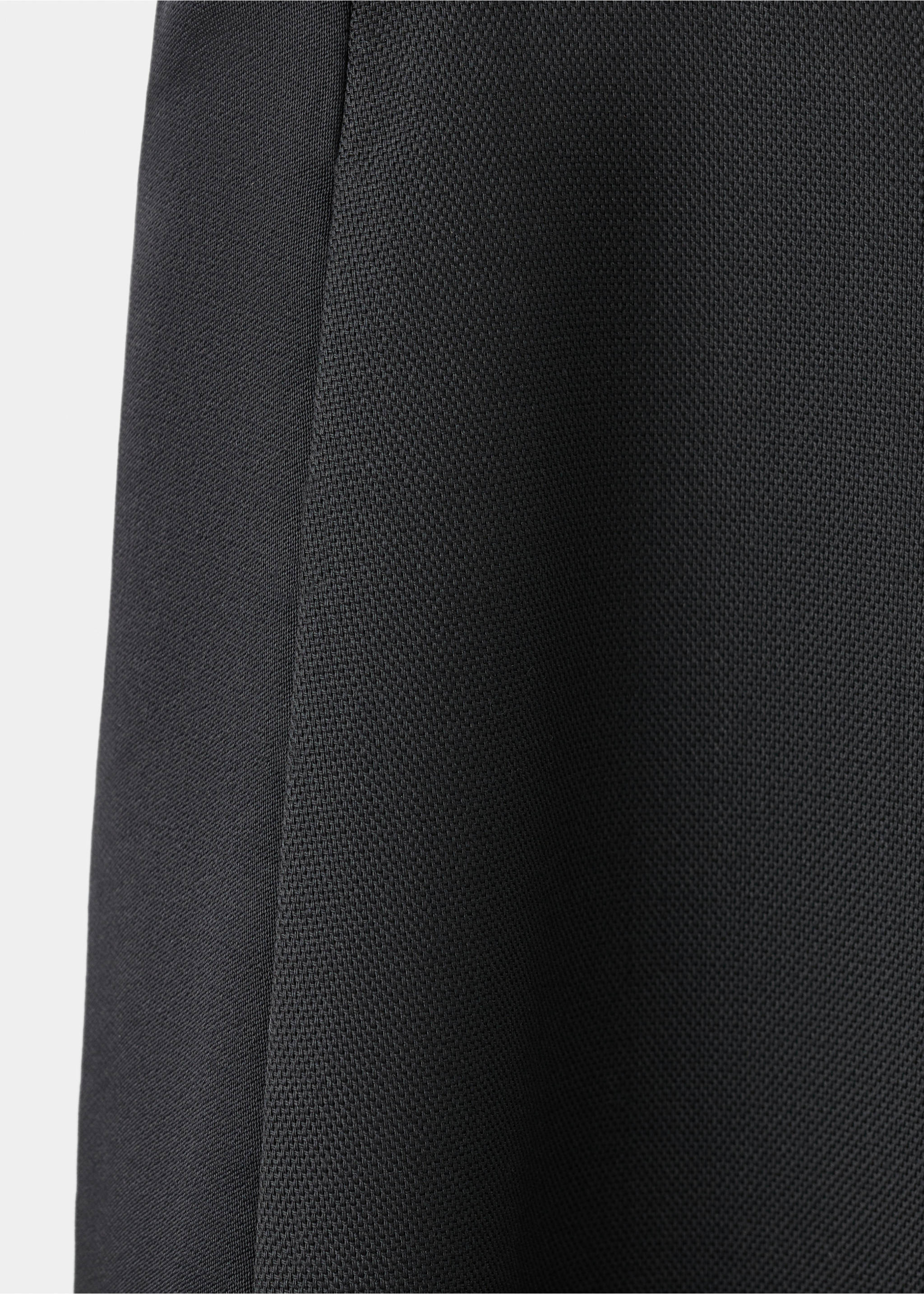 Close-up of black trousers featuring textured fabric and a smooth side stripe., Black. Ref: 17049121-00.