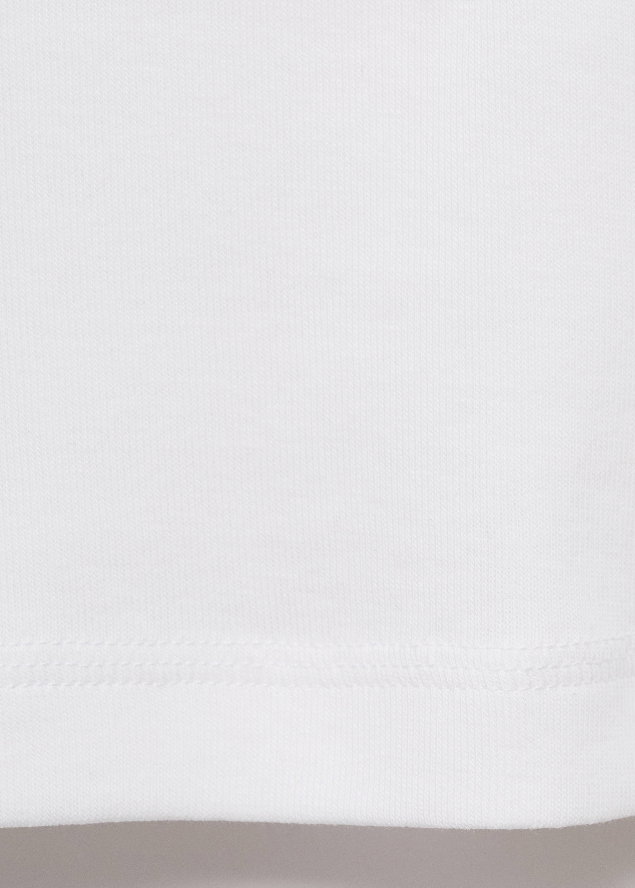 White t-shirt detail showing fabric texture and hem.