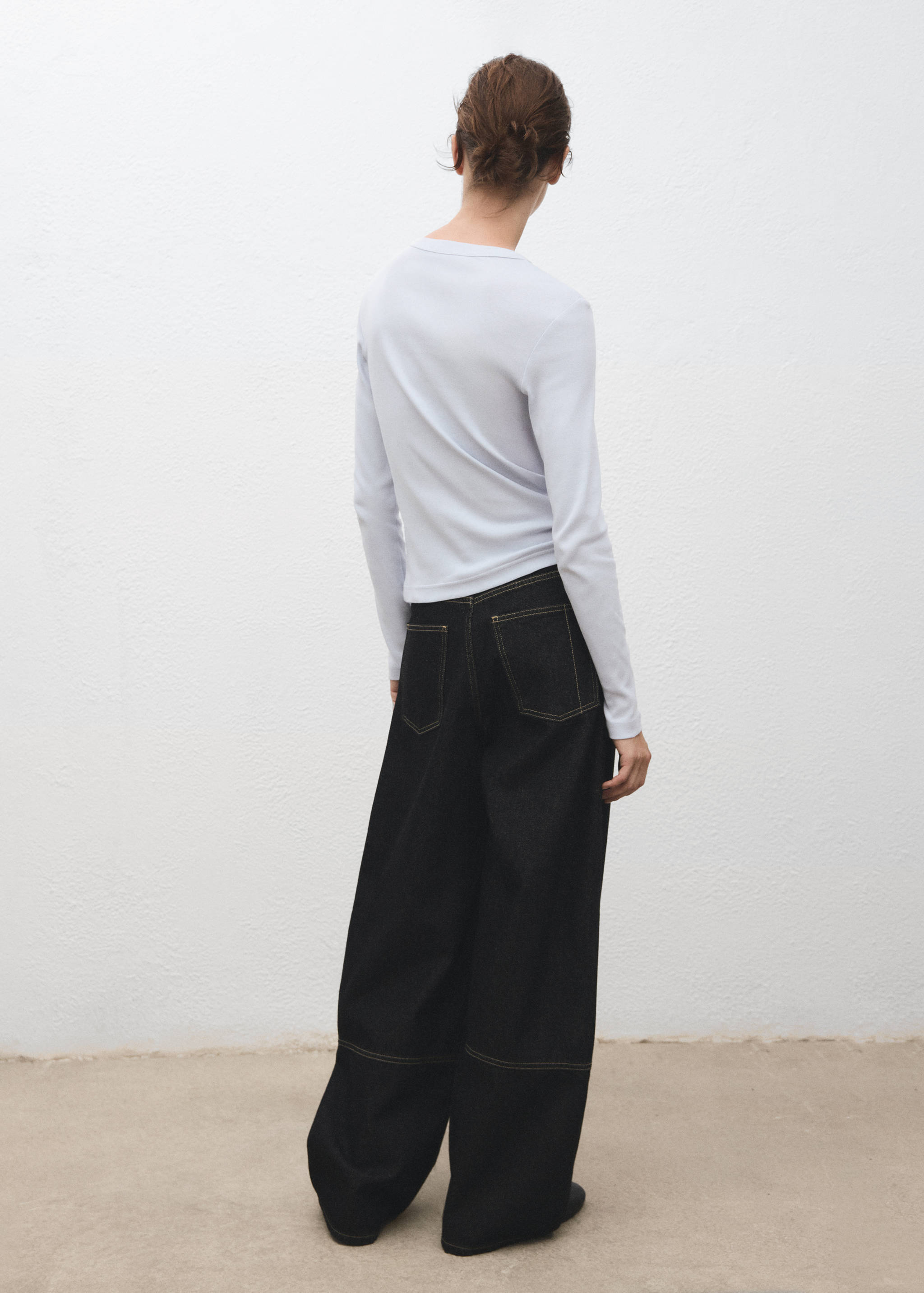 Back view of a pale blue long-sleeved t-shirt with a round neckline.
