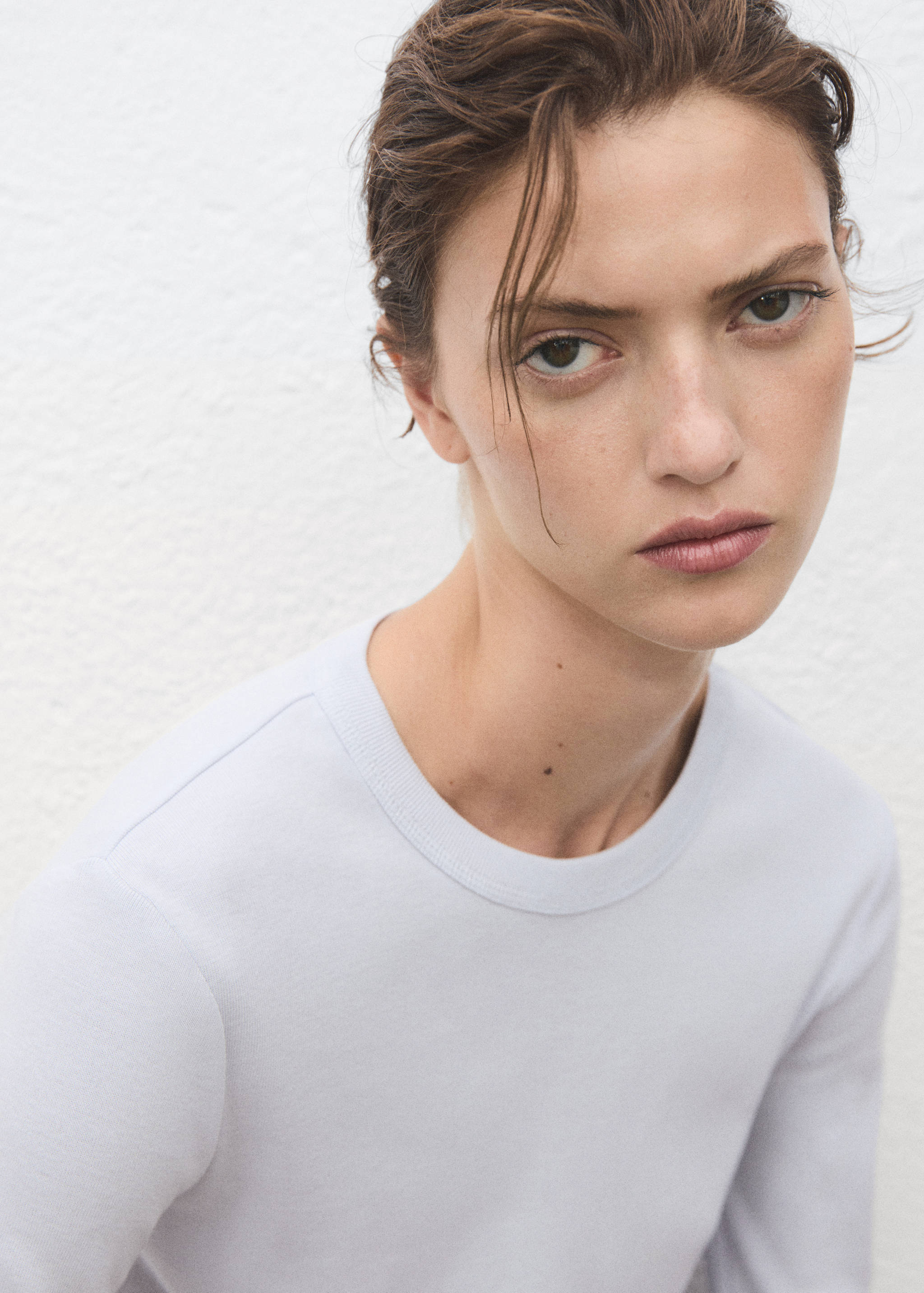 Pale blue long-sleeved t-shirt with a ribbed round neckline.