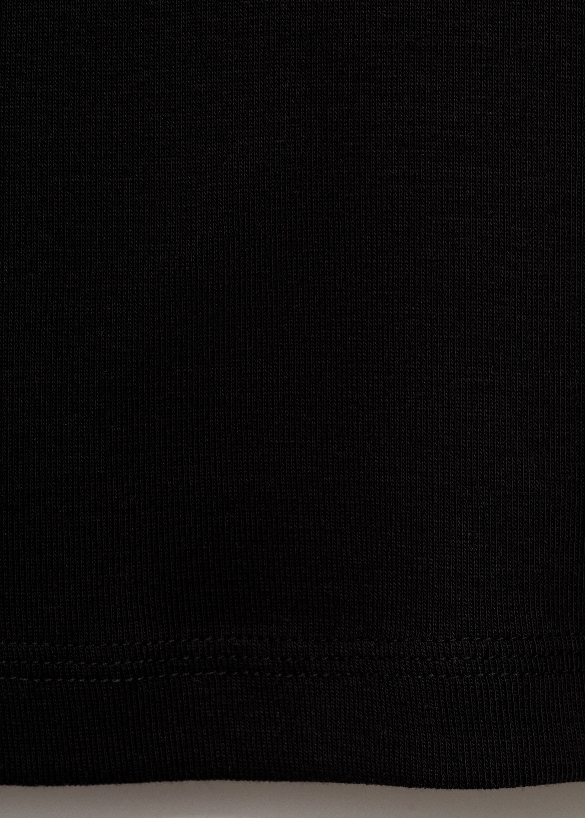 Black t-shirt fabric texture and hem detail