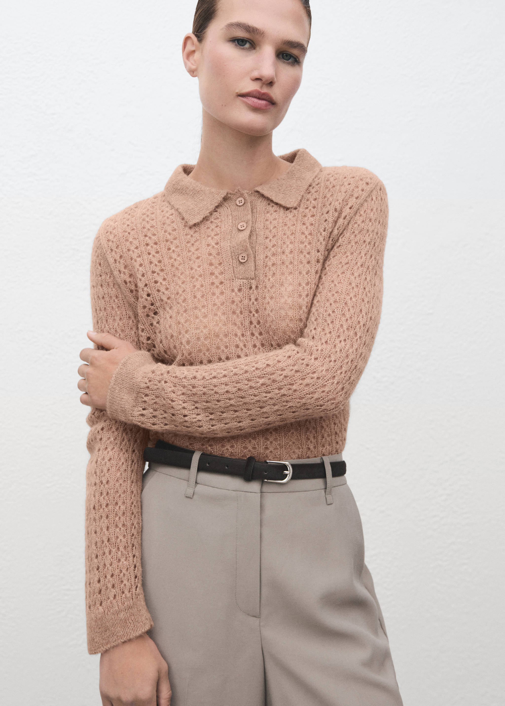 Camel-coloured knitted polo shirt with a pointelle pattern and button placket.