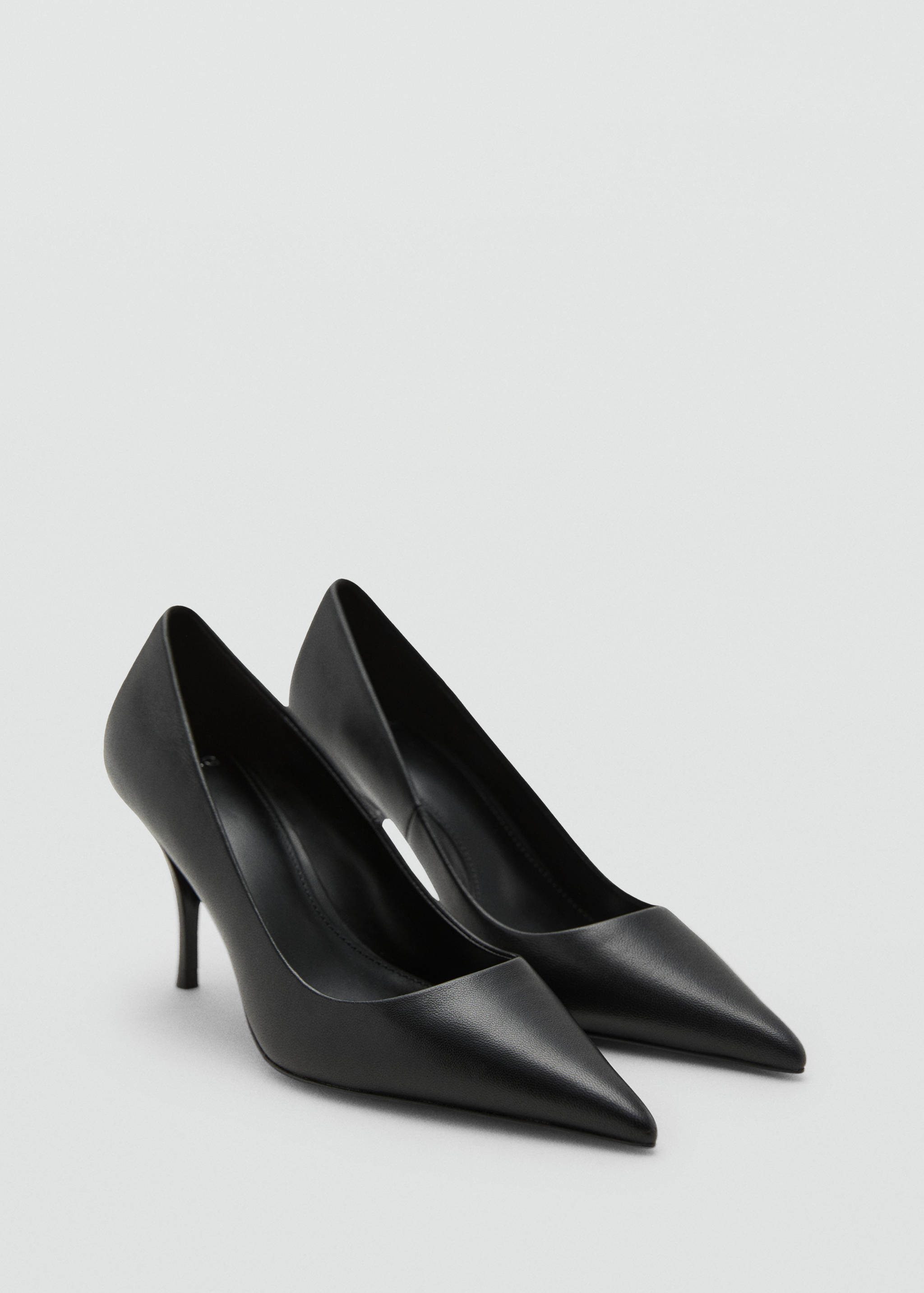 Black pointed-toe high heels with stiletto heels in a three-quarter view.
