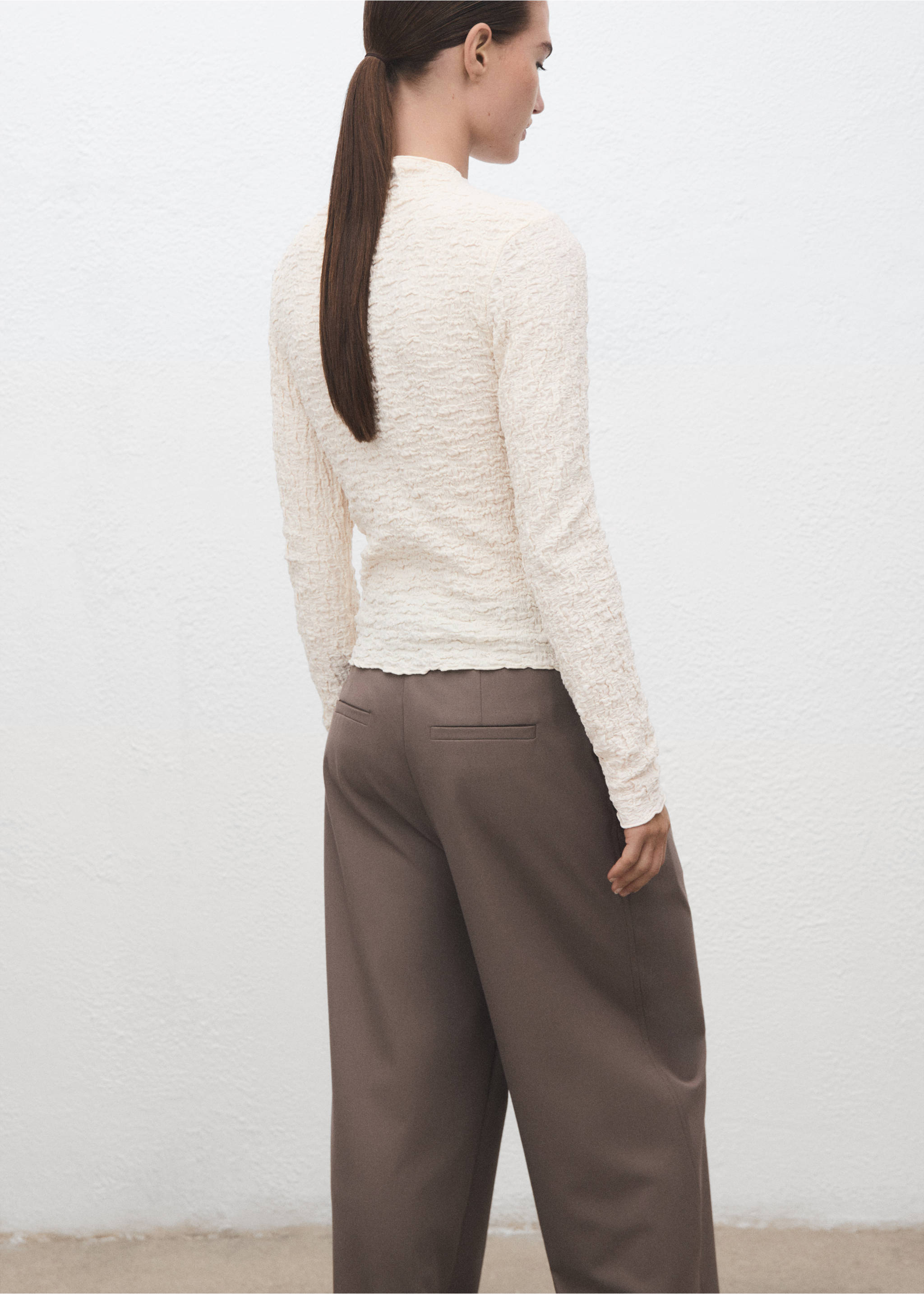 Ecru textured long-sleeved top with a high neck, shown from the back., Ecru. Ref: 17057793-00.